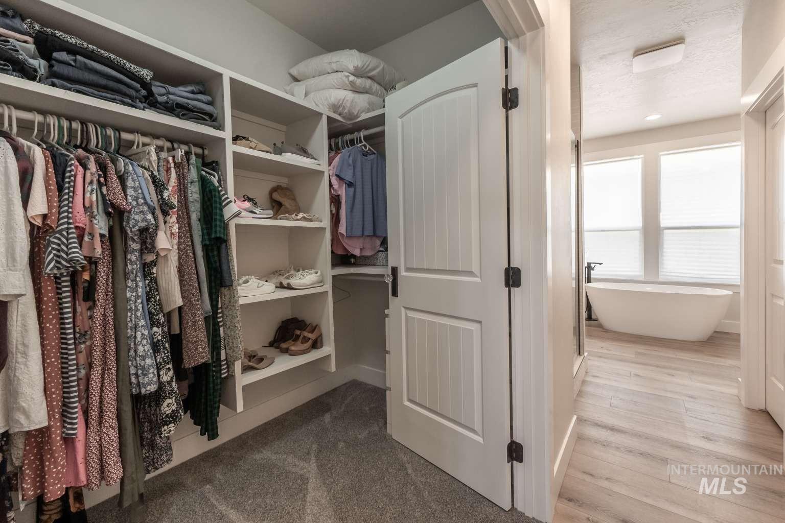 Spacious closet with dark wood finished floors
