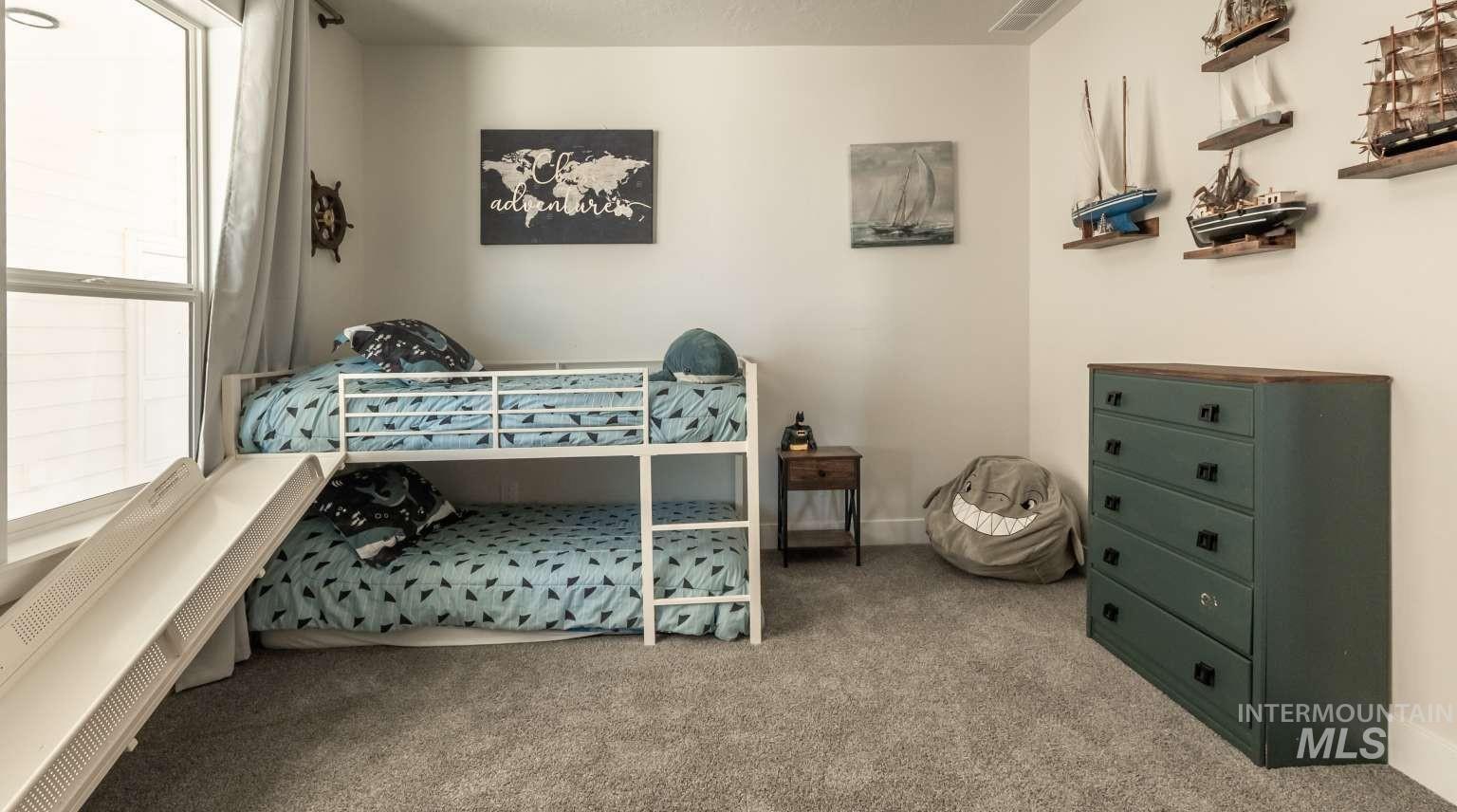 Bedroom featuring light colored carpet and baseboards