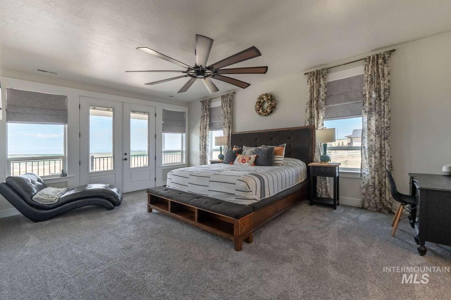 Bedroom with carpet, access to outside, a ceiling fan, a textured ceiling, and french doors