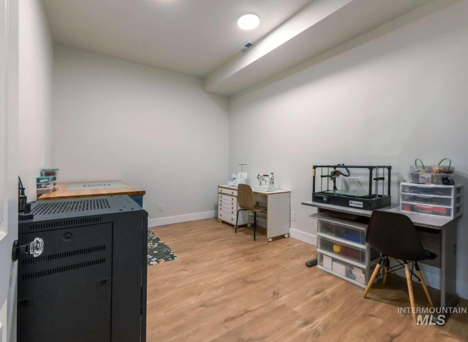 Office with light wood-style floors and baseboards