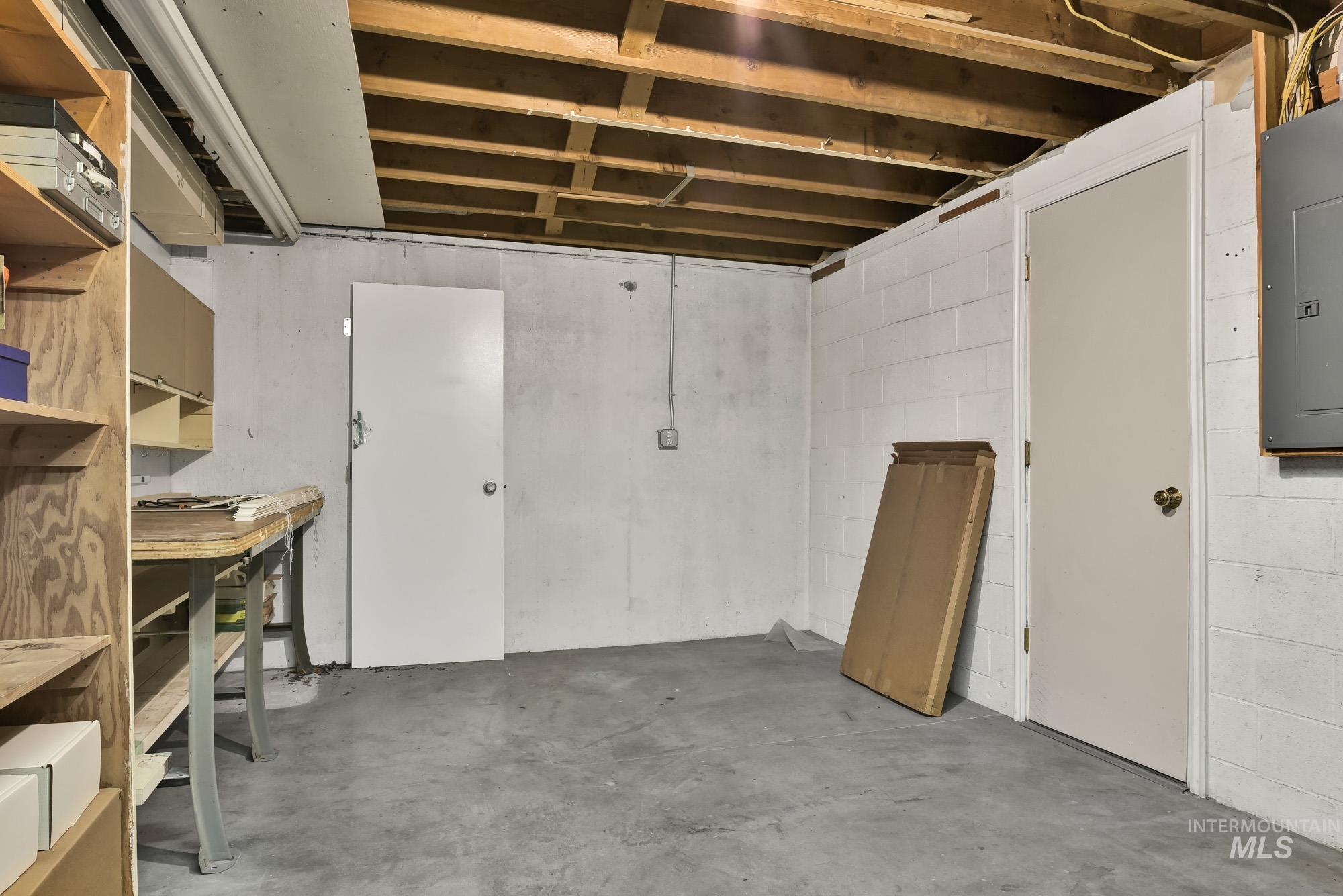 Unfinished below grade area featuring electric panel