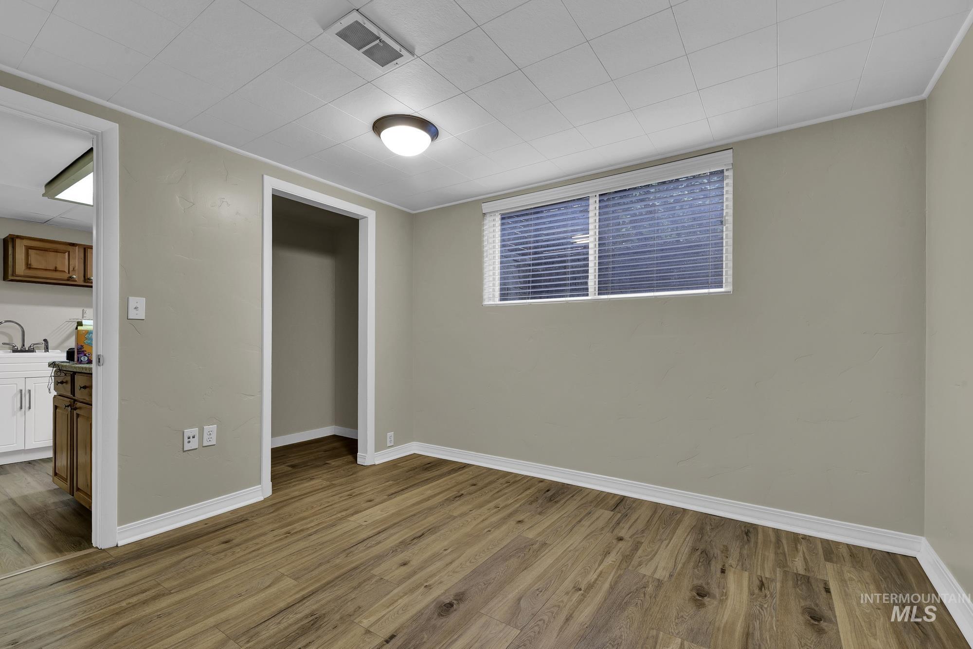 Unfurnished bedroom with light wood finished floors and a closet