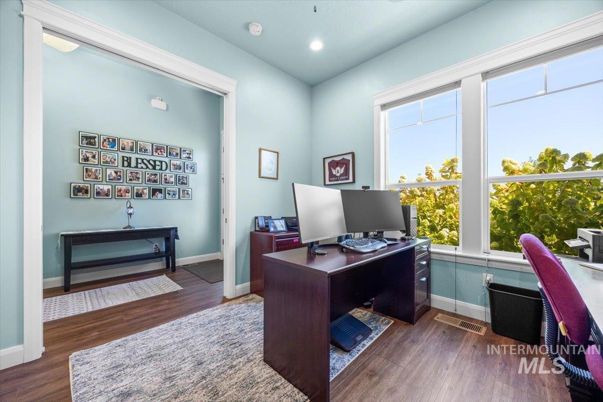 Home office featuring dark wood finished floors and recessed lighting
