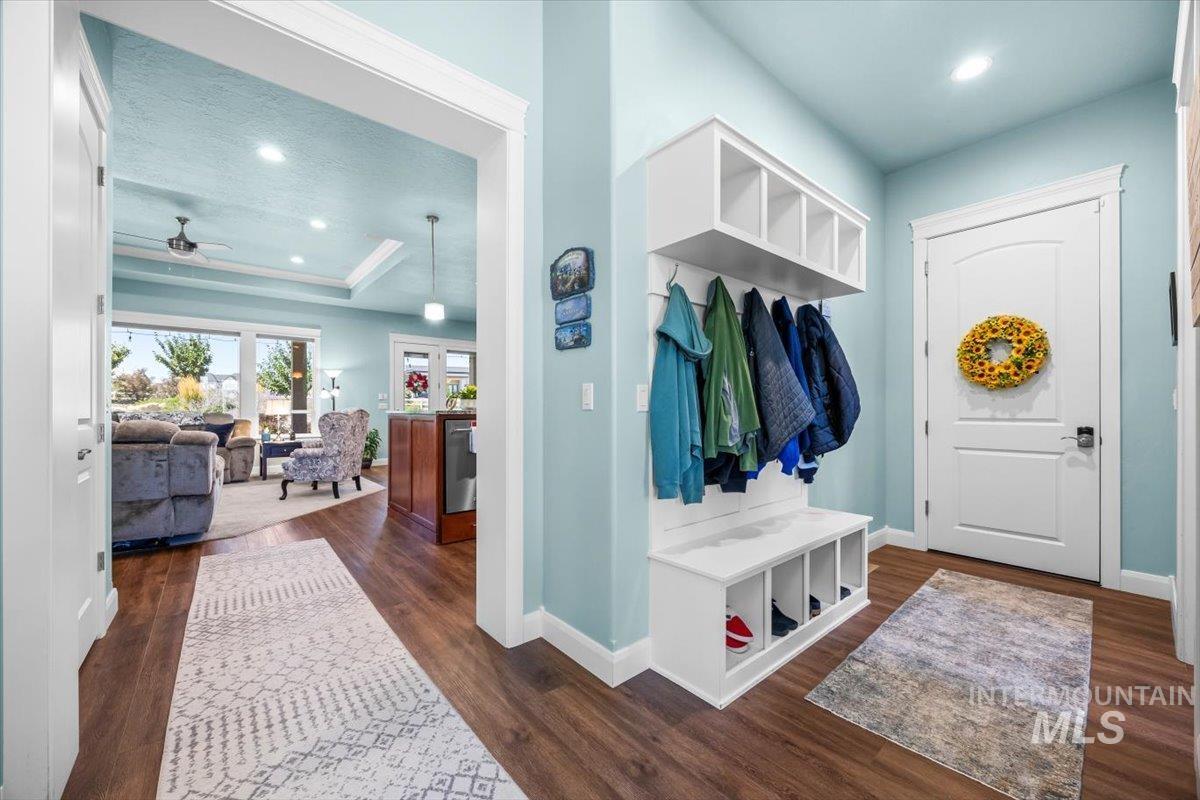 Mudroom with dark wood-style flooring, recessed lighting, a raised ceiling, and ceiling fan