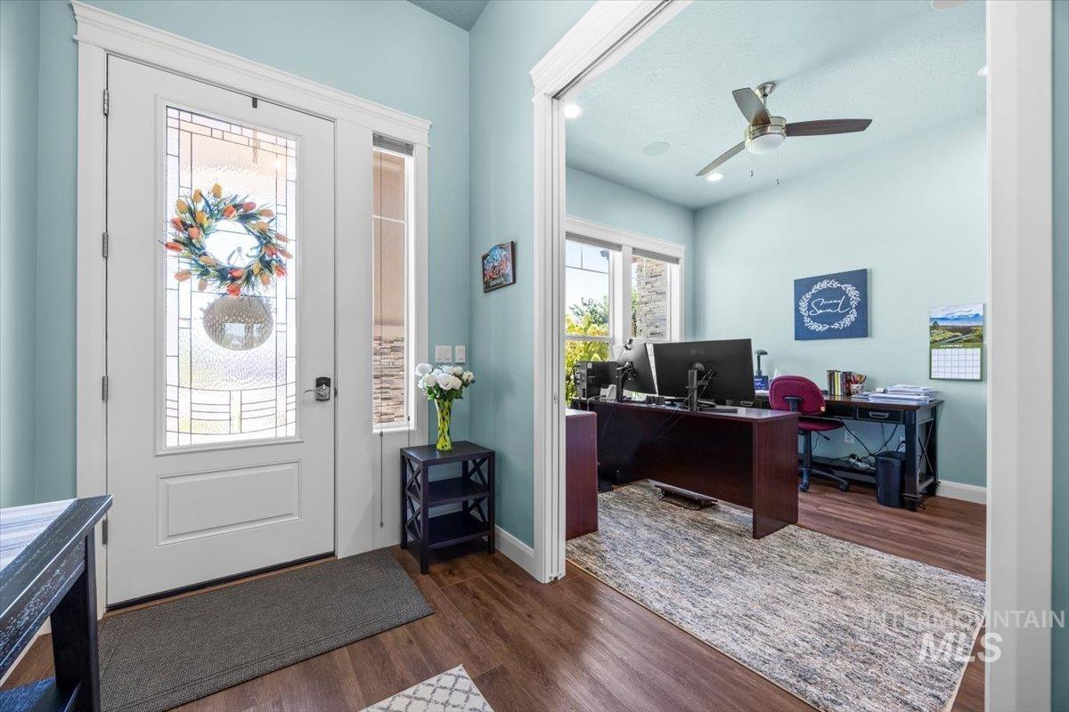 Foyer with dark wood-type flooring and a ceiling fan