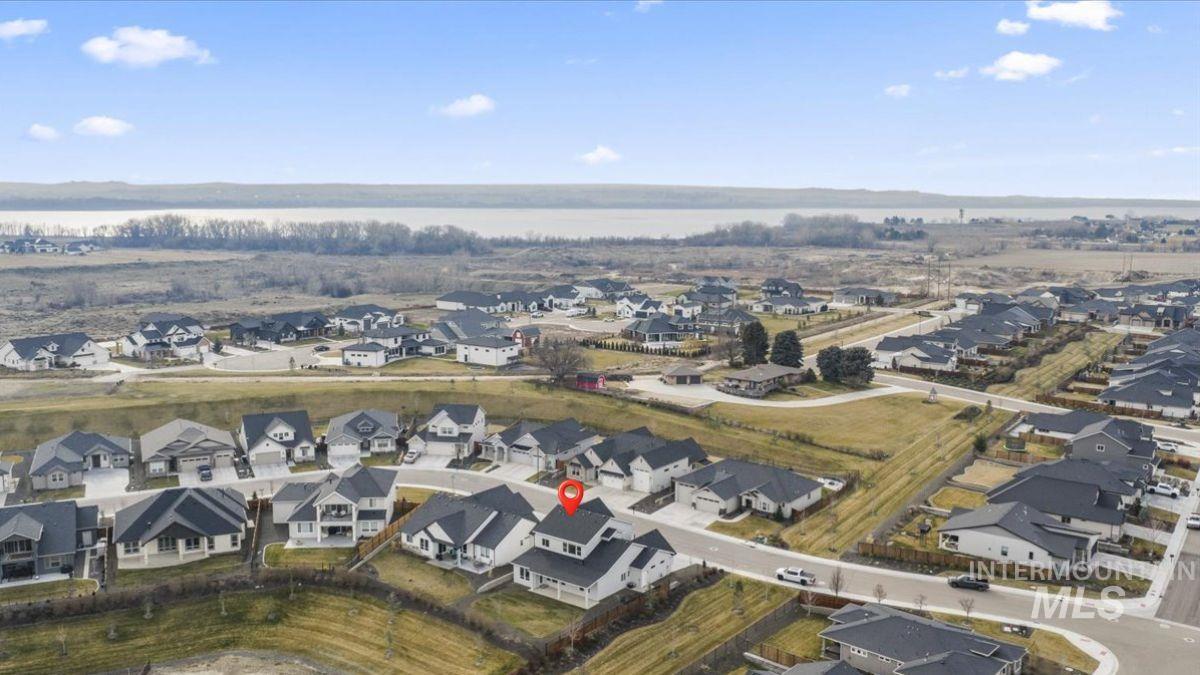 Aerial view of property's location featuring nearby suburban area and a nearby body of water