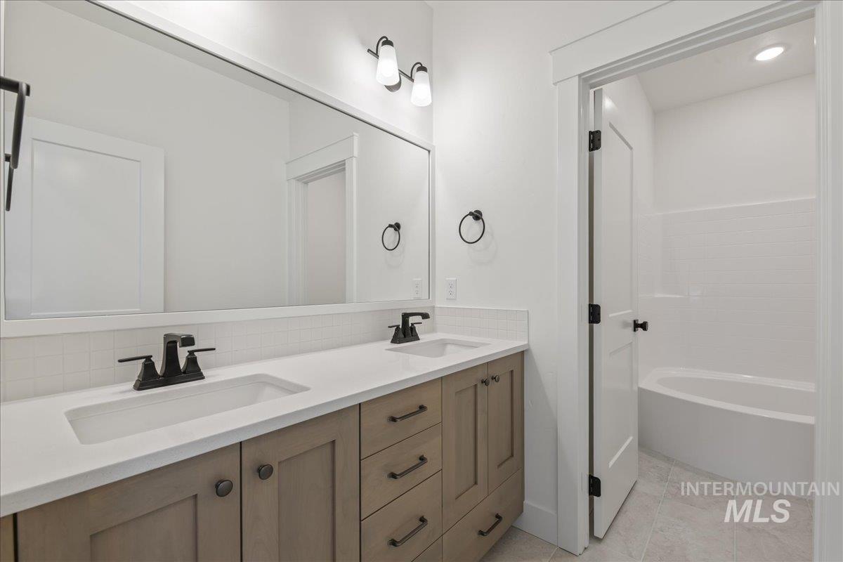 Full bath with double vanity and recessed lighting