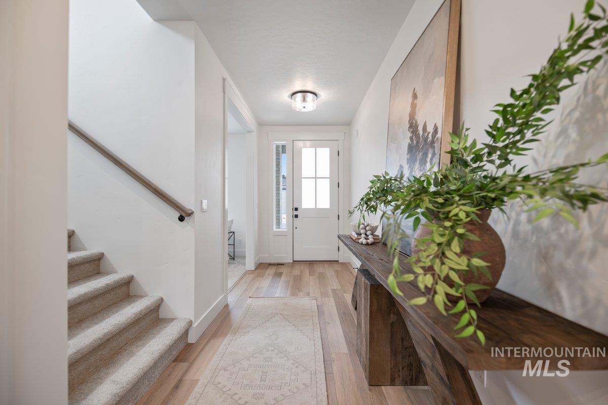 Foyer with stairway and light wood finished floors