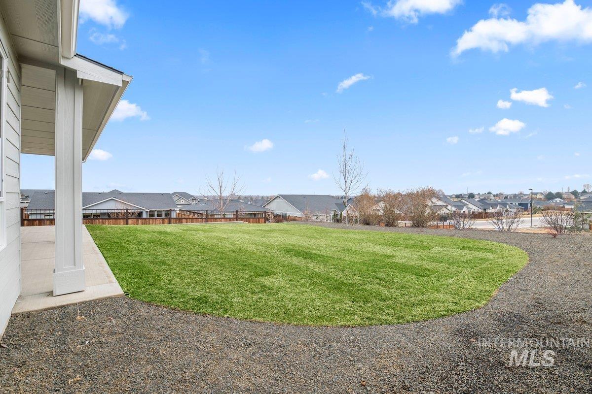 Fenced backyard featuring a residential view and a patio