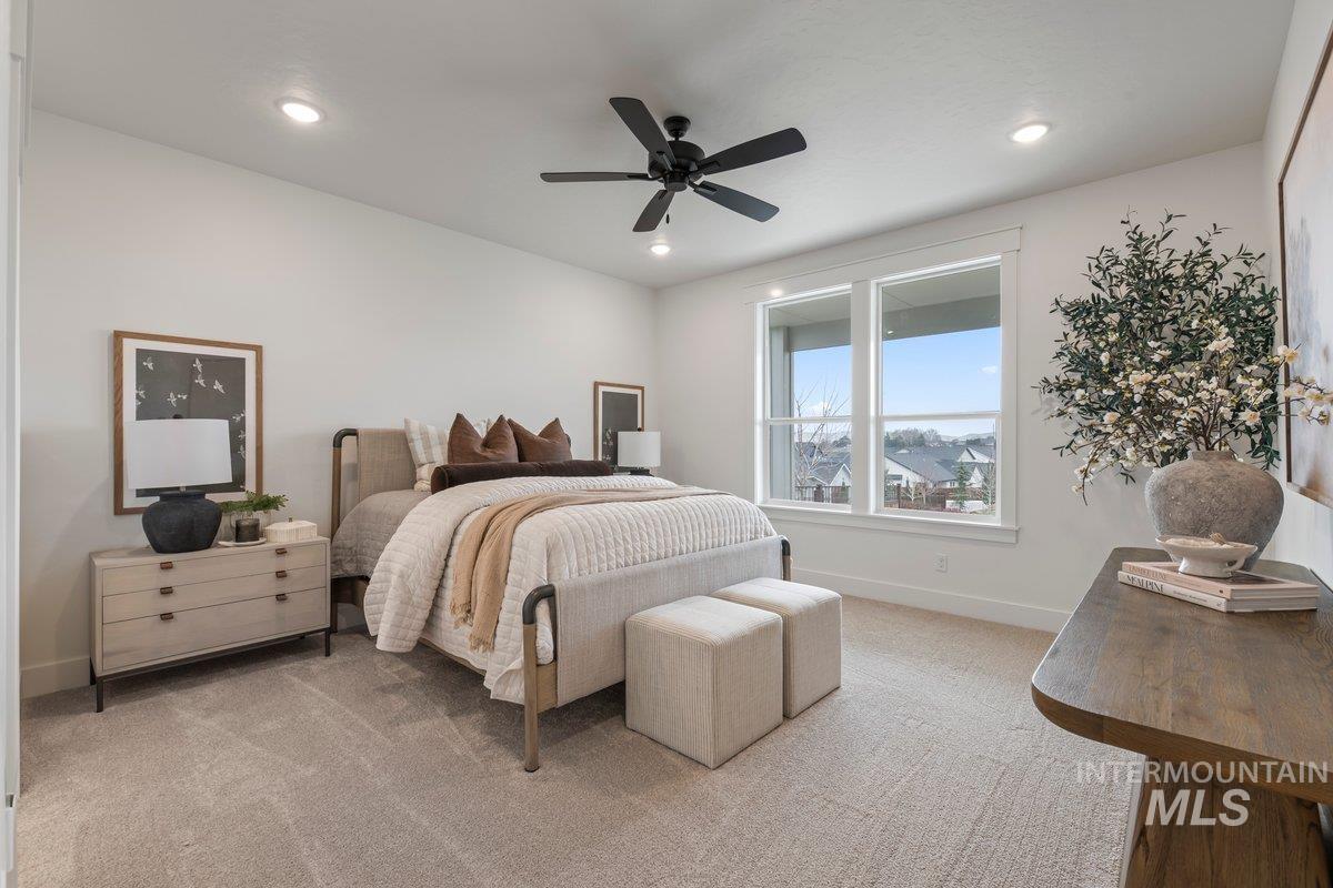 Bedroom with ceiling fan, light colored carpet, and recessed lighting