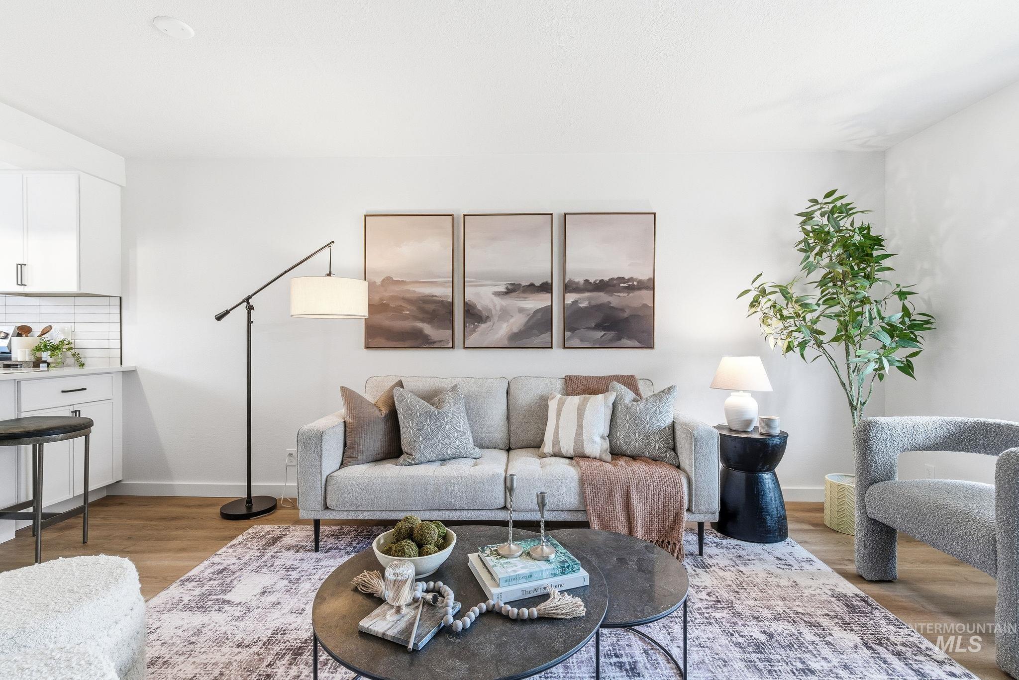 Living room featuring light wood-style flooring and baseboards