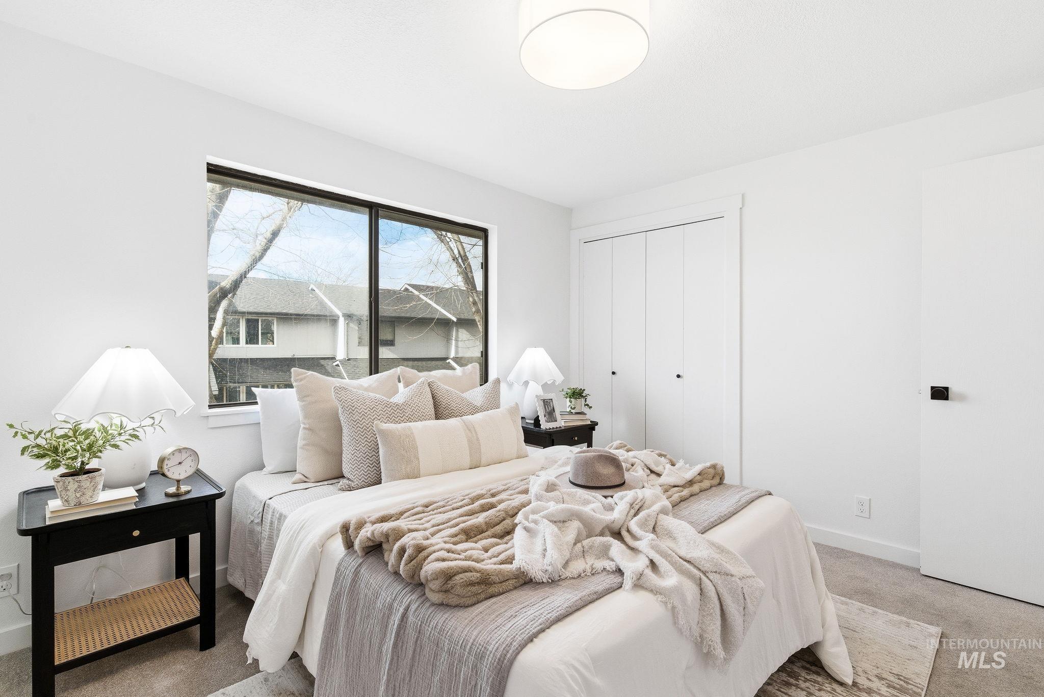 Carpeted bedroom featuring baseboards and a closet