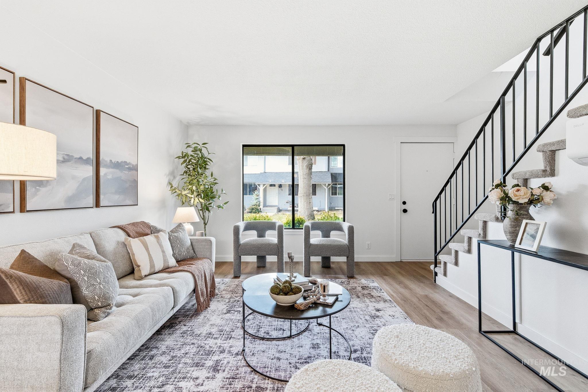 Living area with stairway and wood finished floors