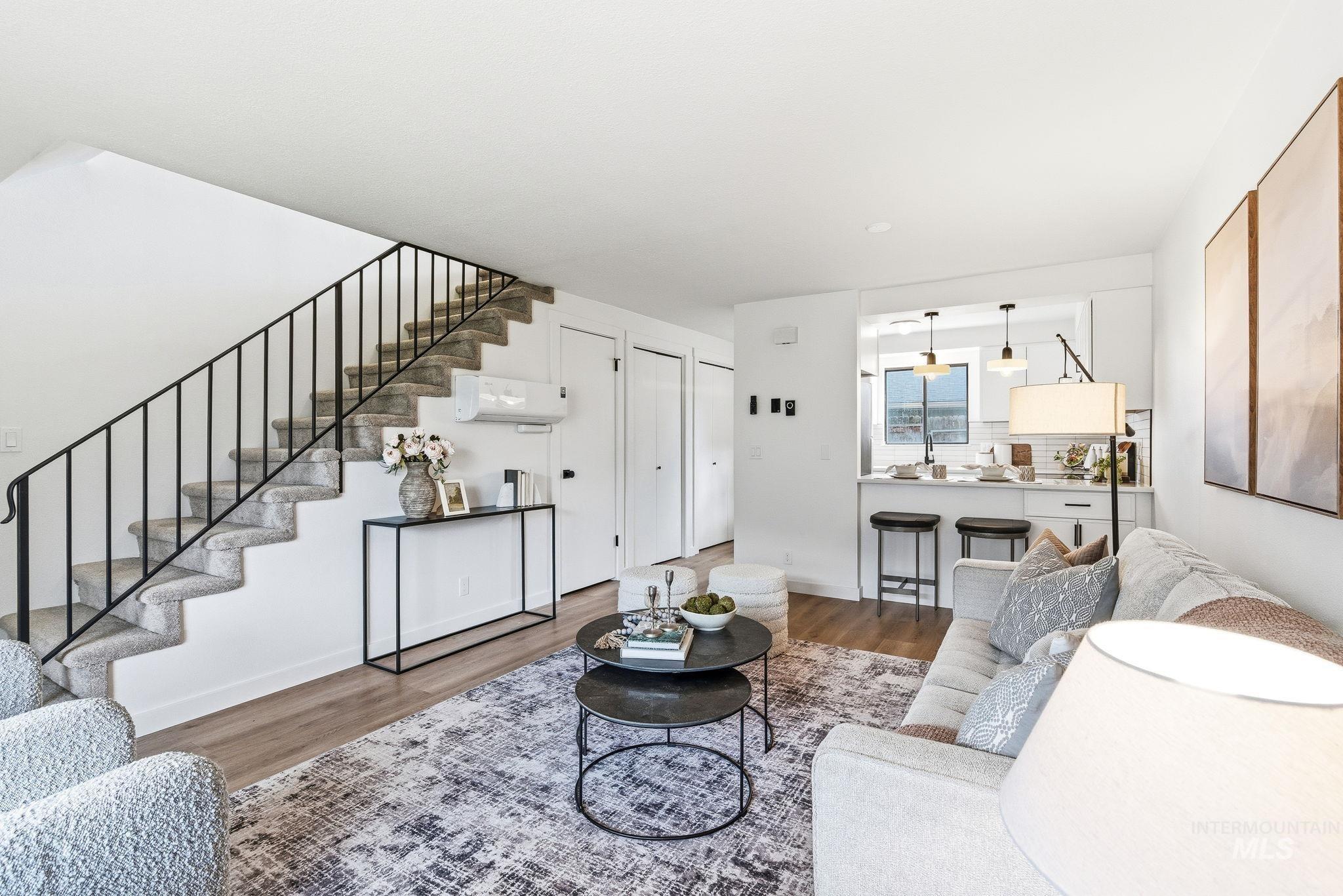 Living room with stairway and wood finished floors