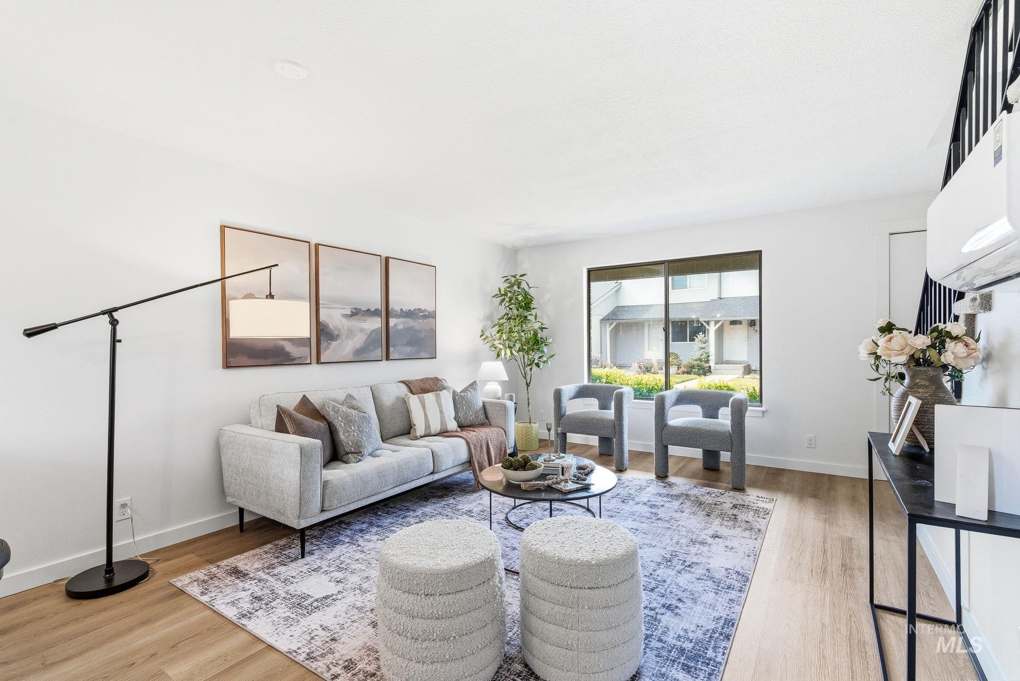Living room featuring light wood-style floors and baseboards