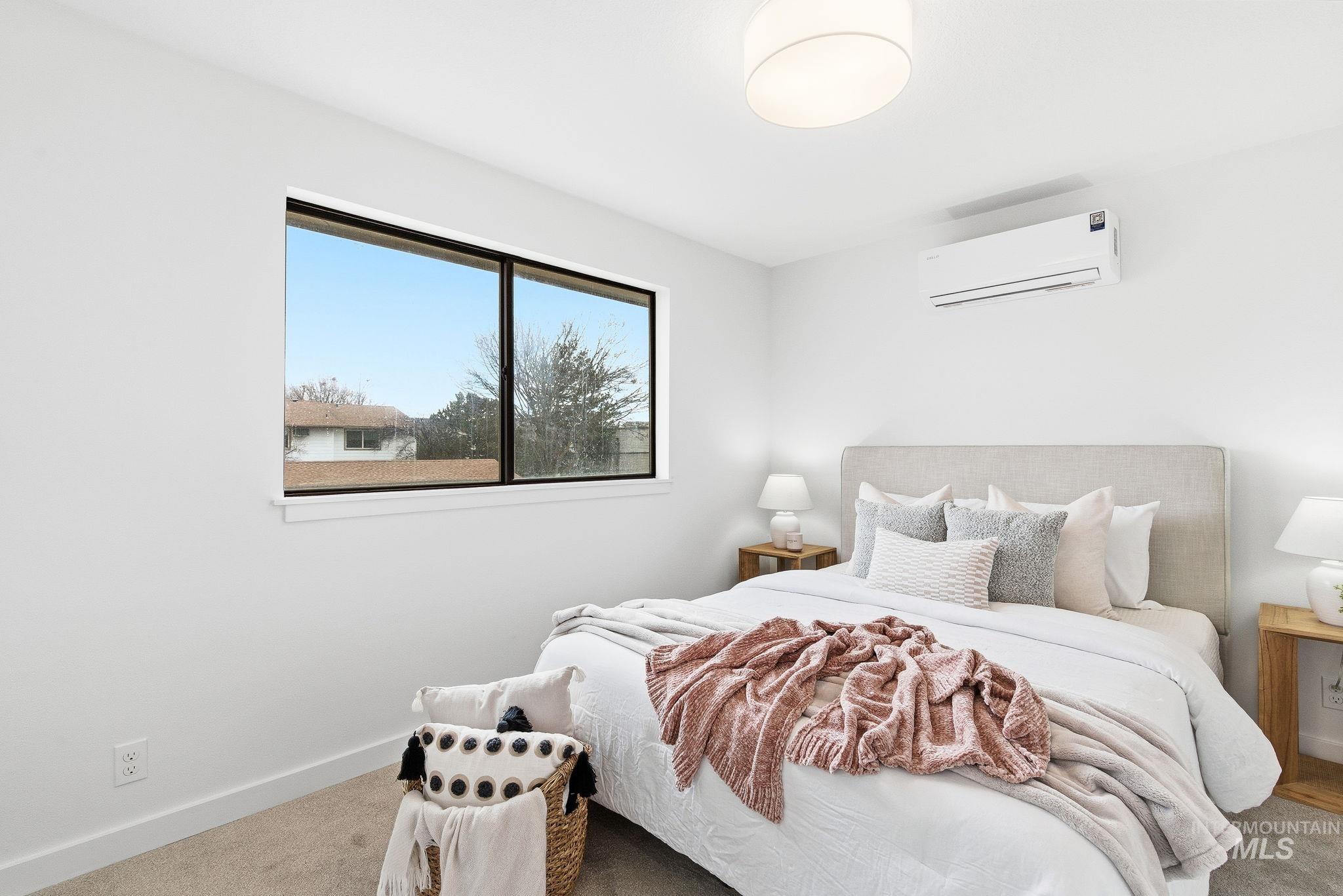 Bedroom with carpet flooring and a mini split for heating / cooling