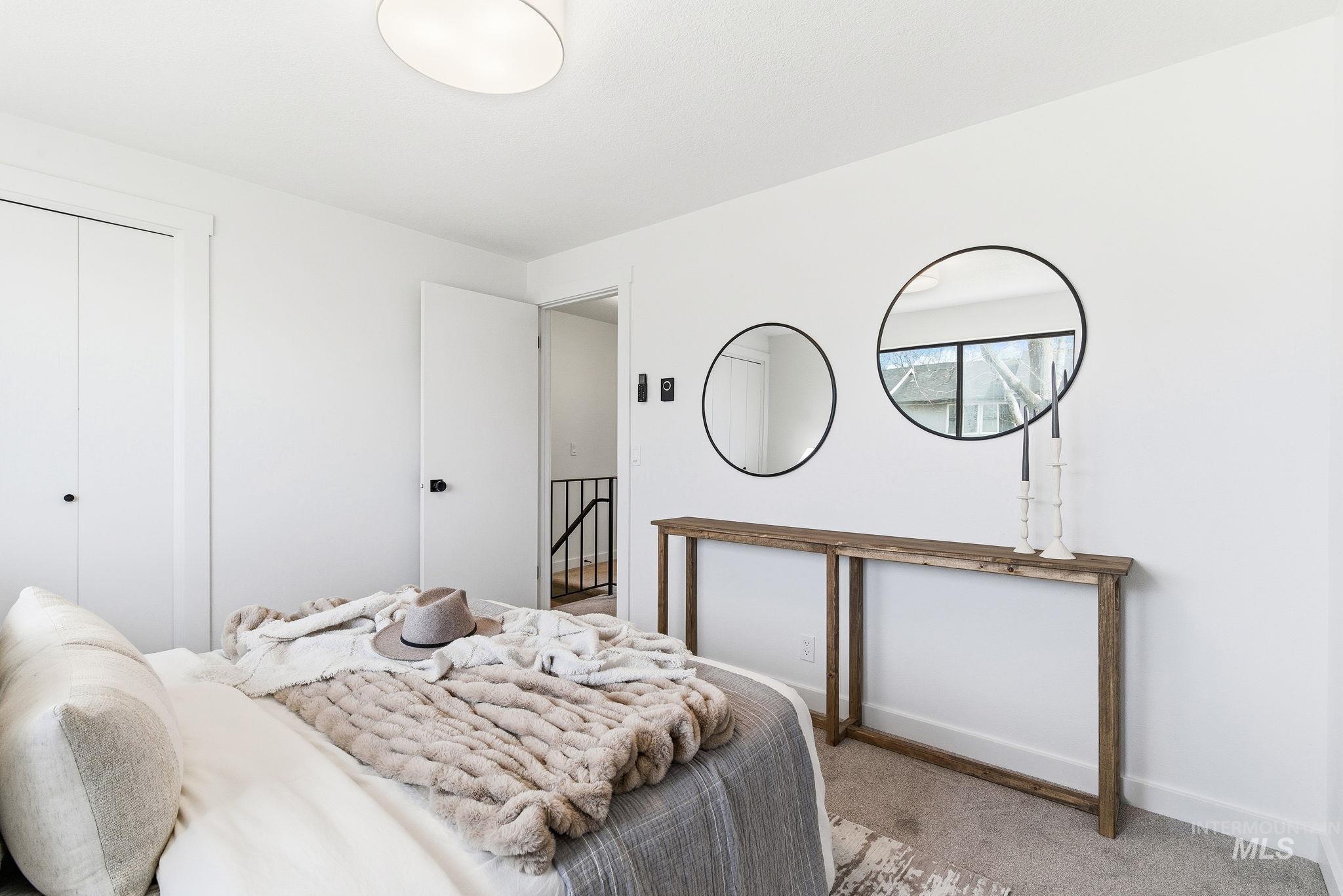 Carpeted bedroom featuring baseboards and a closet