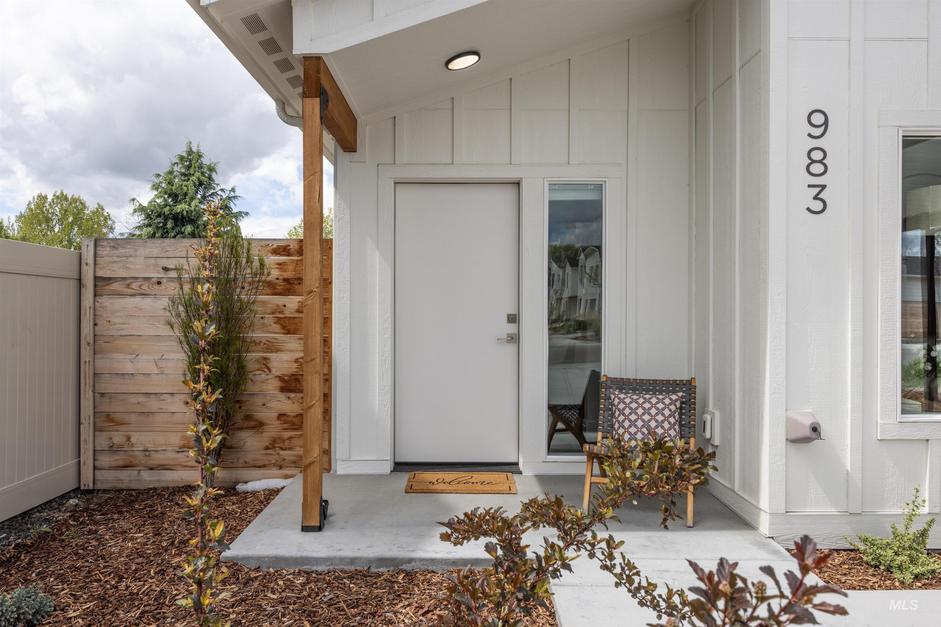 Doorway to property featuring board and batten siding