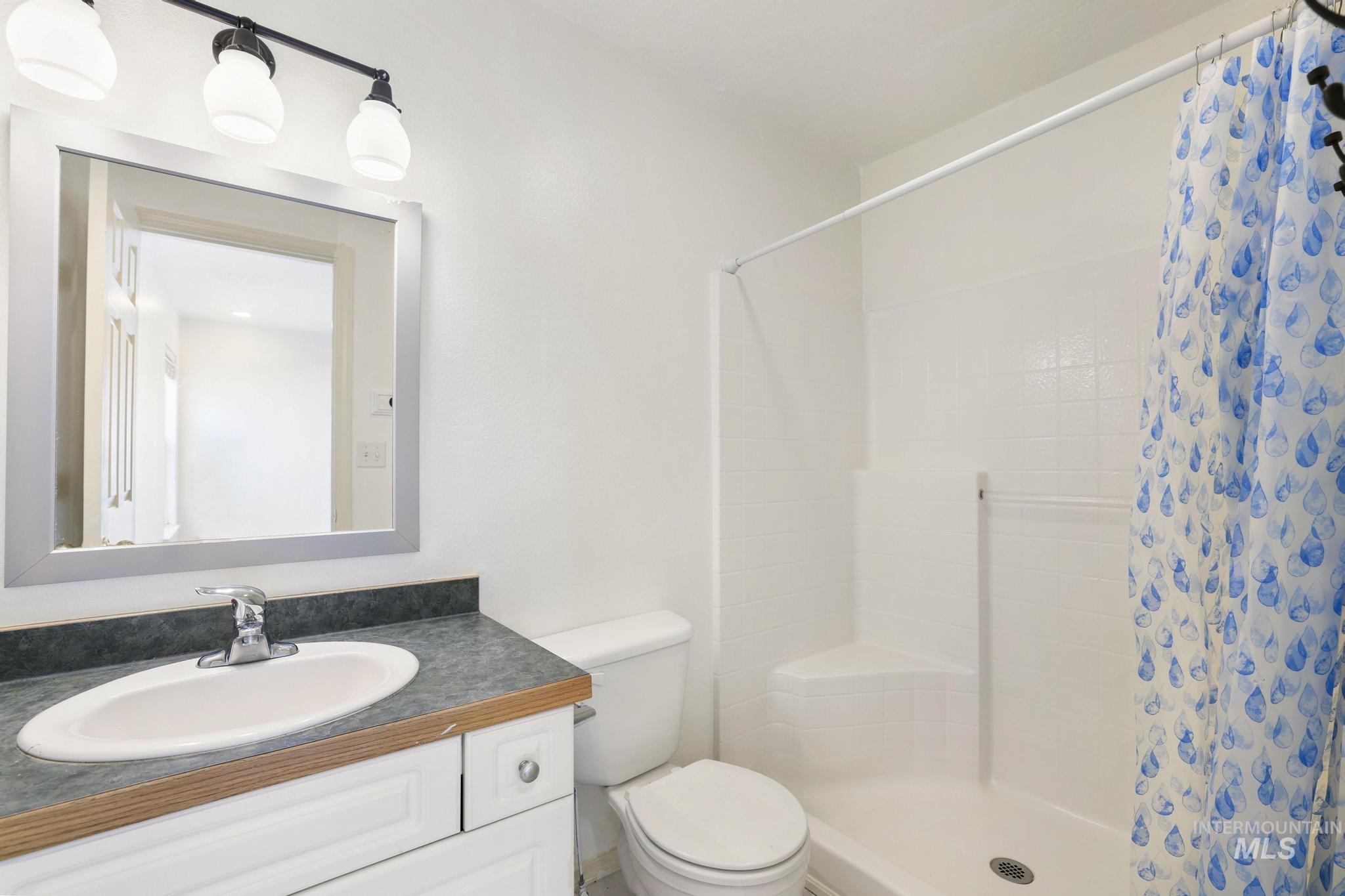 Bathroom with vanity and a stall shower