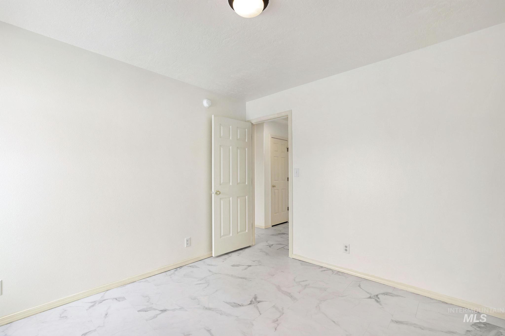 Unfurnished room with baseboards