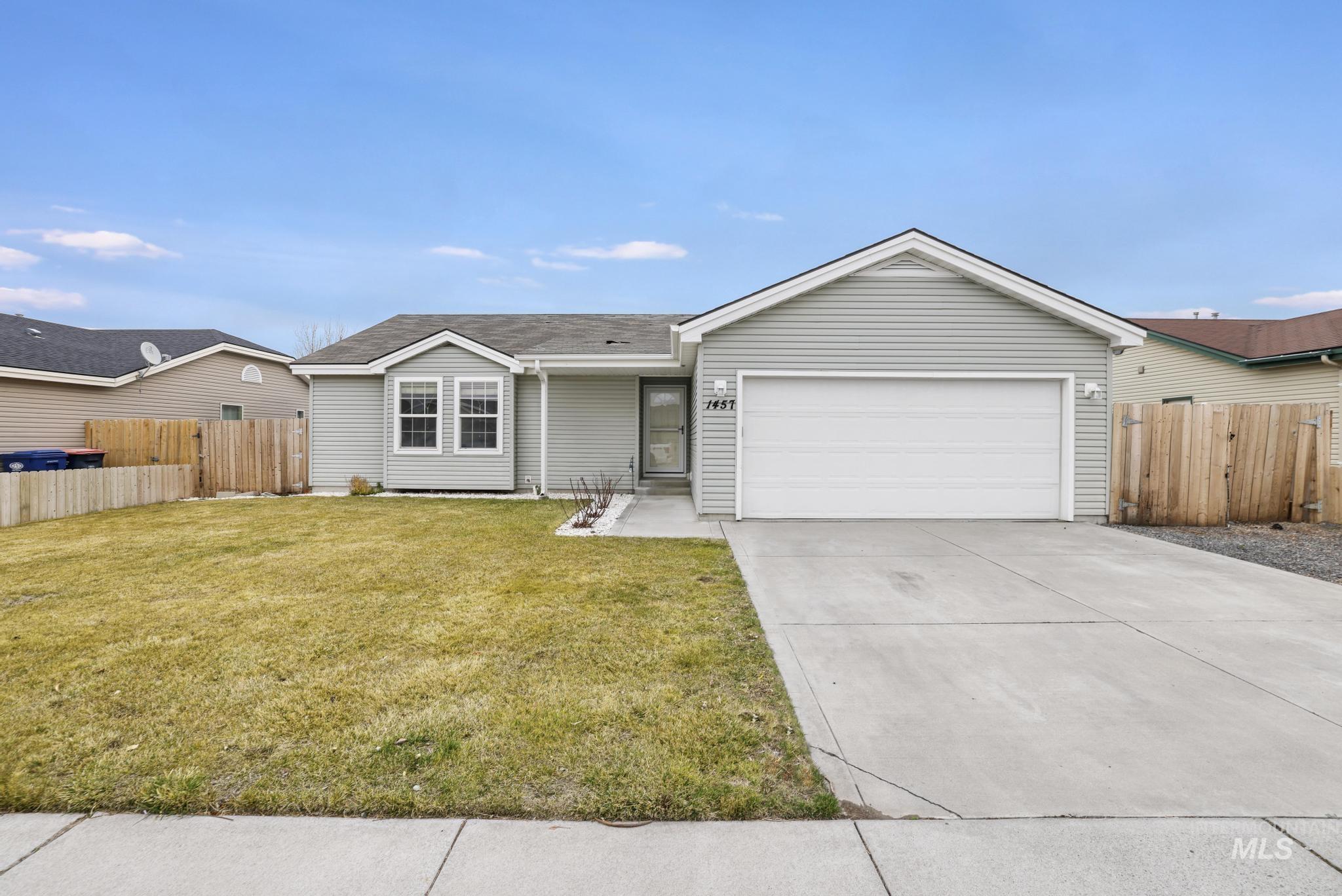 Single story home with concrete driveway, a garage, and a shingled roof