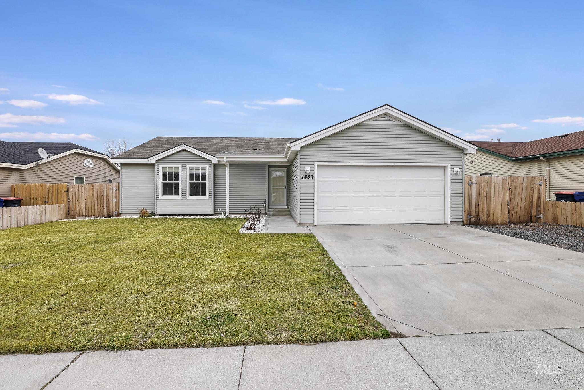 Ranch-style house featuring concrete driveway, an attached garage, and a shingled roof
