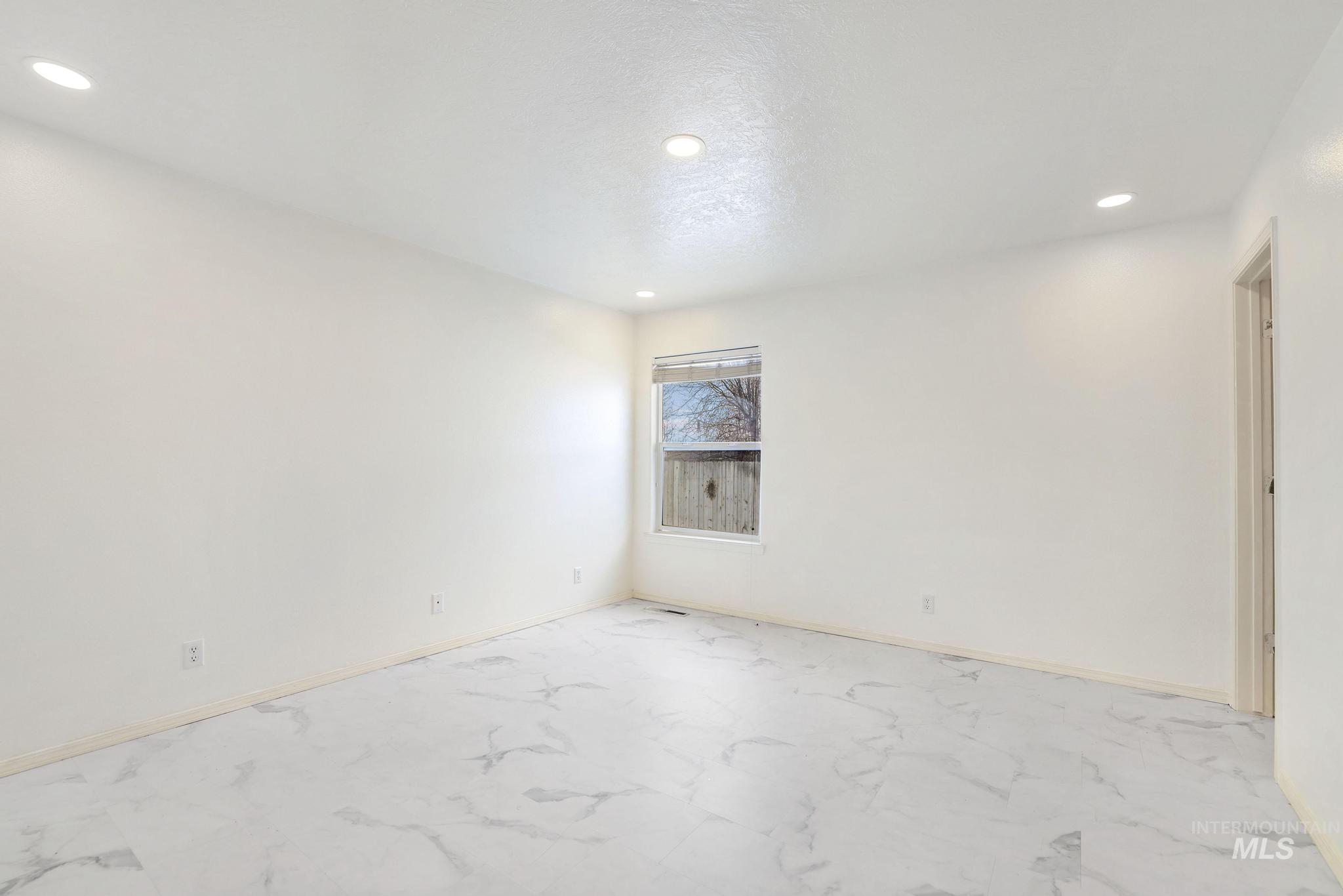 Unfurnished room with recessed lighting and light marble finish floors