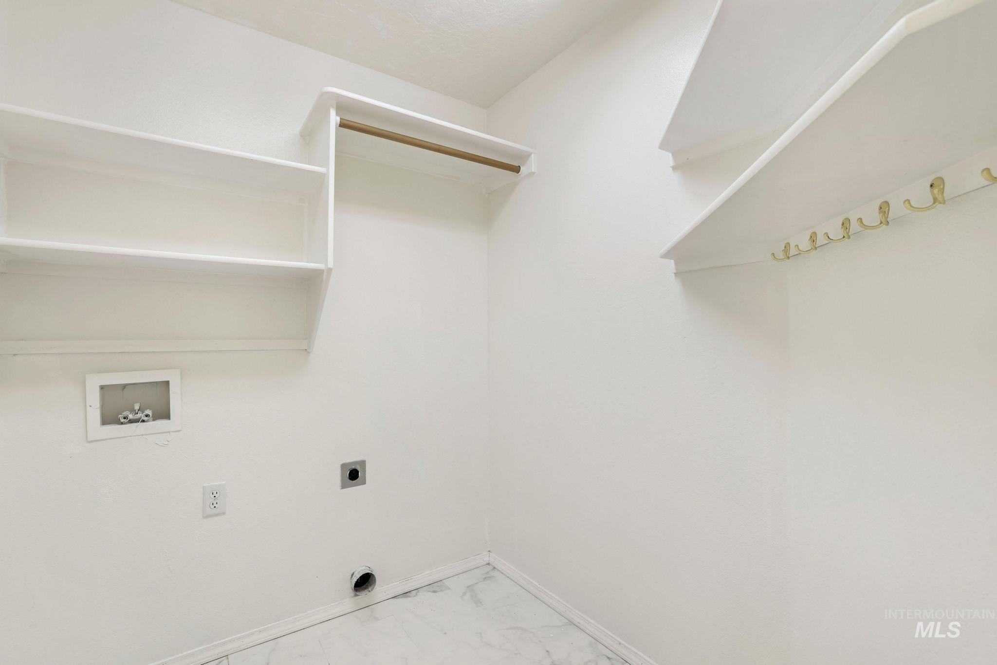 Laundry area with light marble finish flooring, washer hookup, and electric dryer hookup