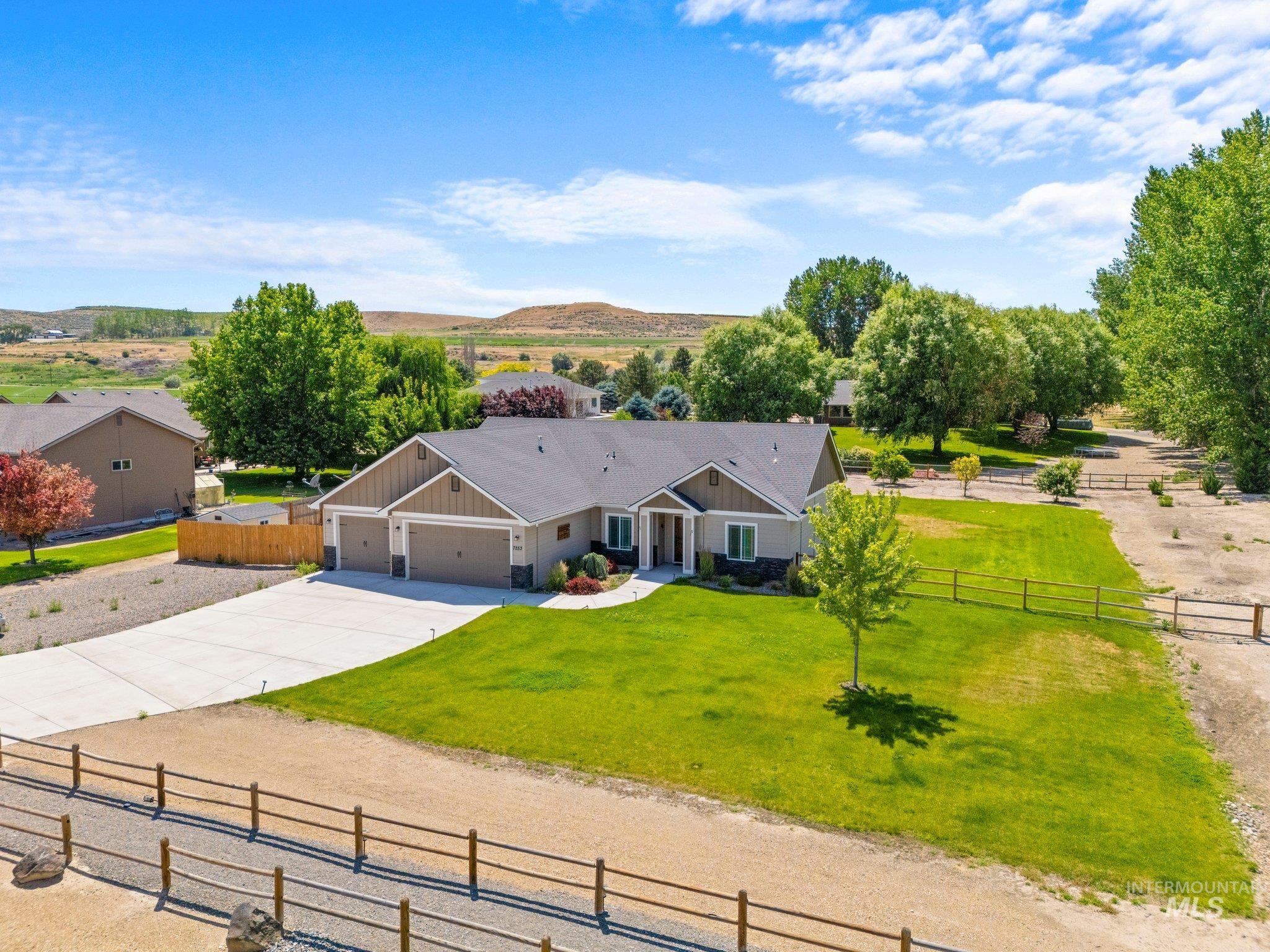View of front of home featuring board and batten siding, concrete driveway, and an attached garage