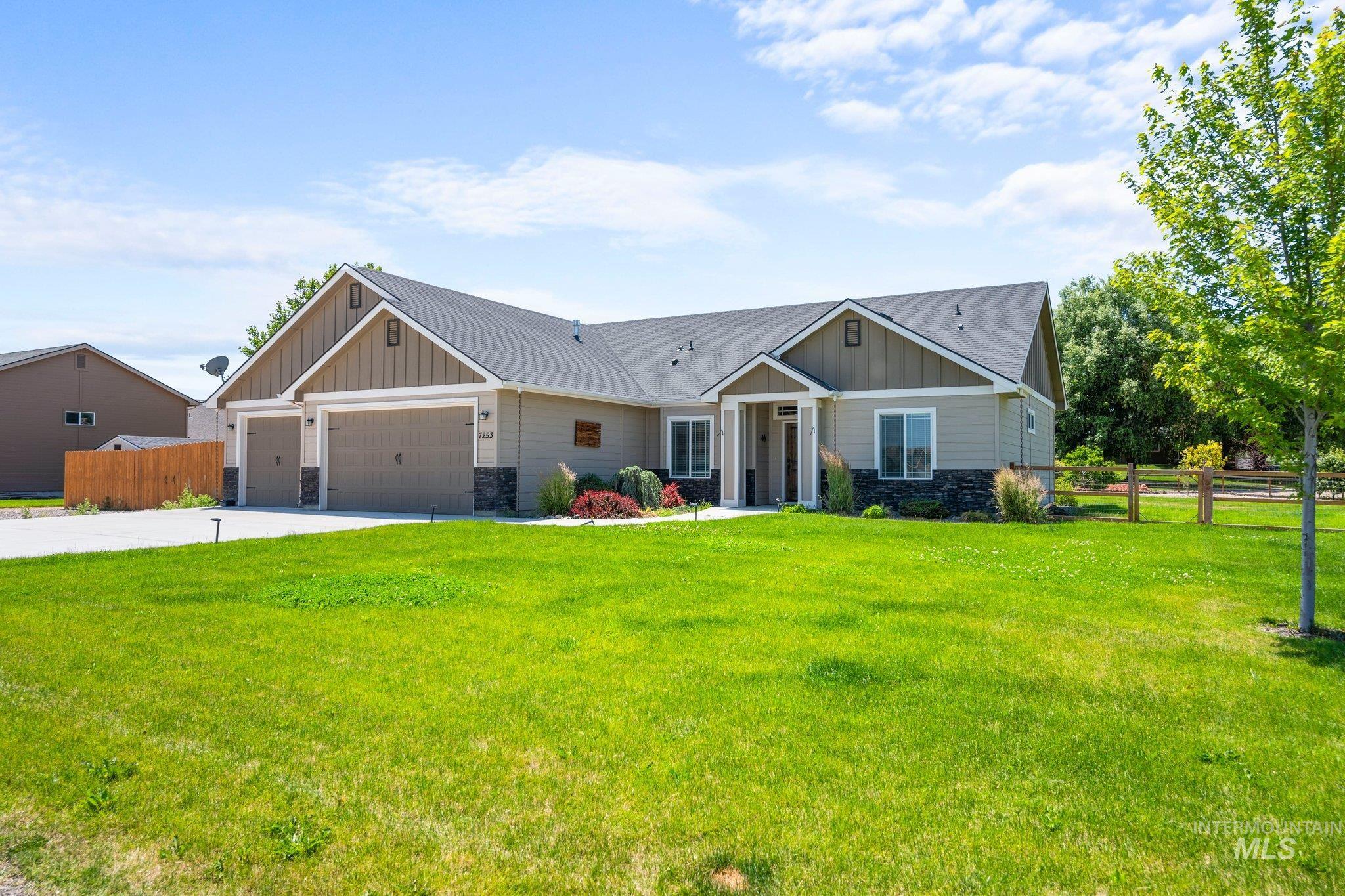 Craftsman house with board and batten siding, stone siding, and an attached garage