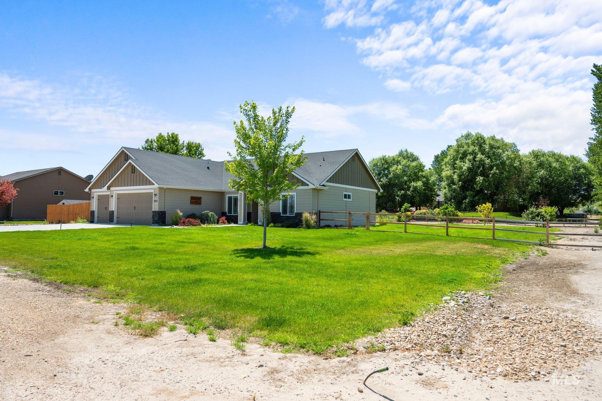 View of front of home with a garage, concrete driveway, and board and batten siding