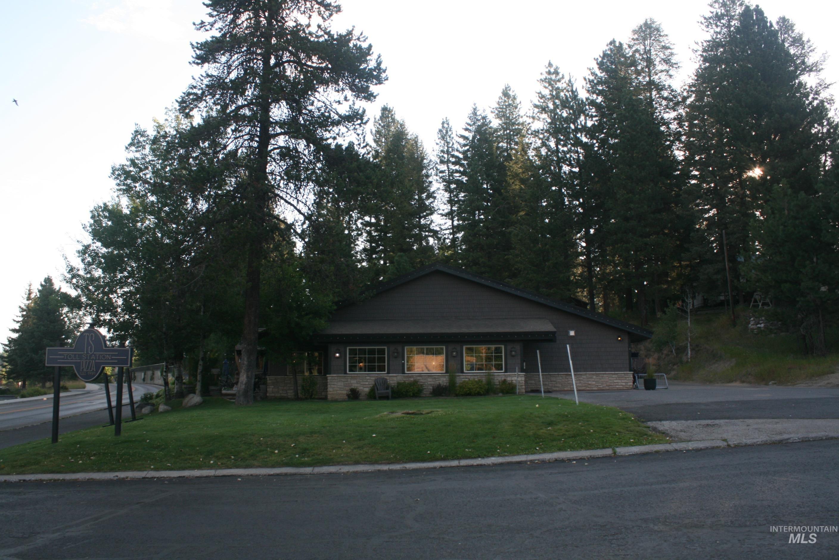 View of front of property featuring a front yard and stone siding