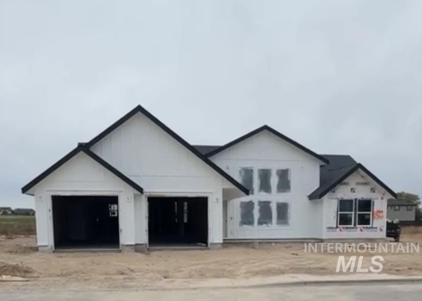 View of front of home featuring an attached garage and driveway