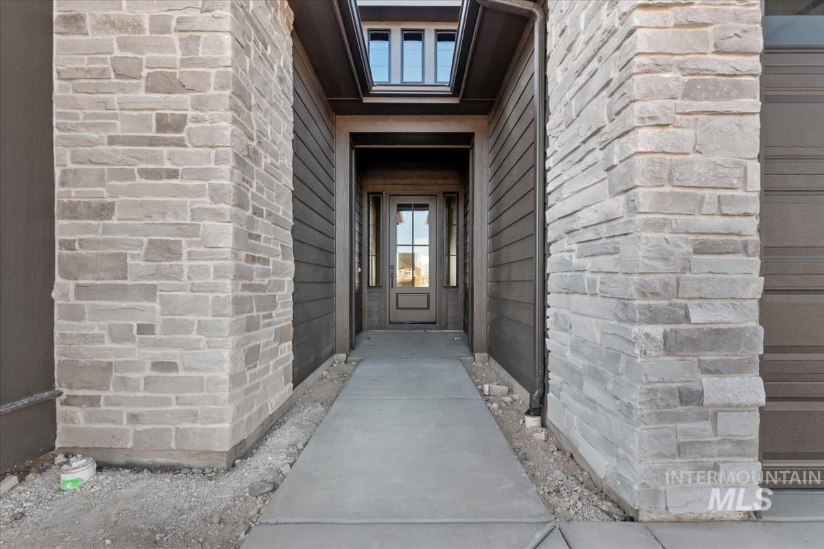 View of exterior entry with stone siding
