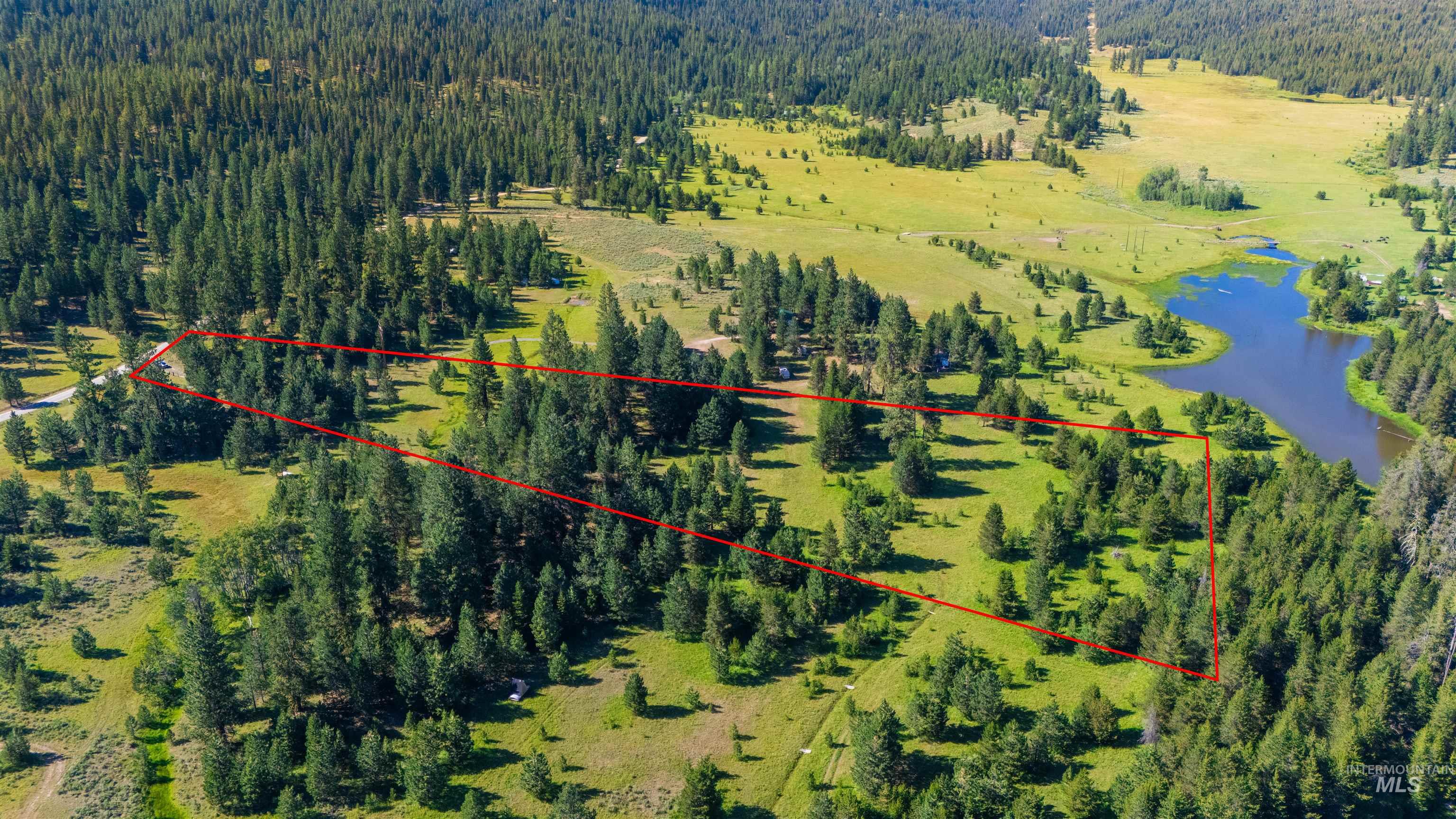 Aerial view of property's location featuring a nearby body of water and property boundaries highlighted