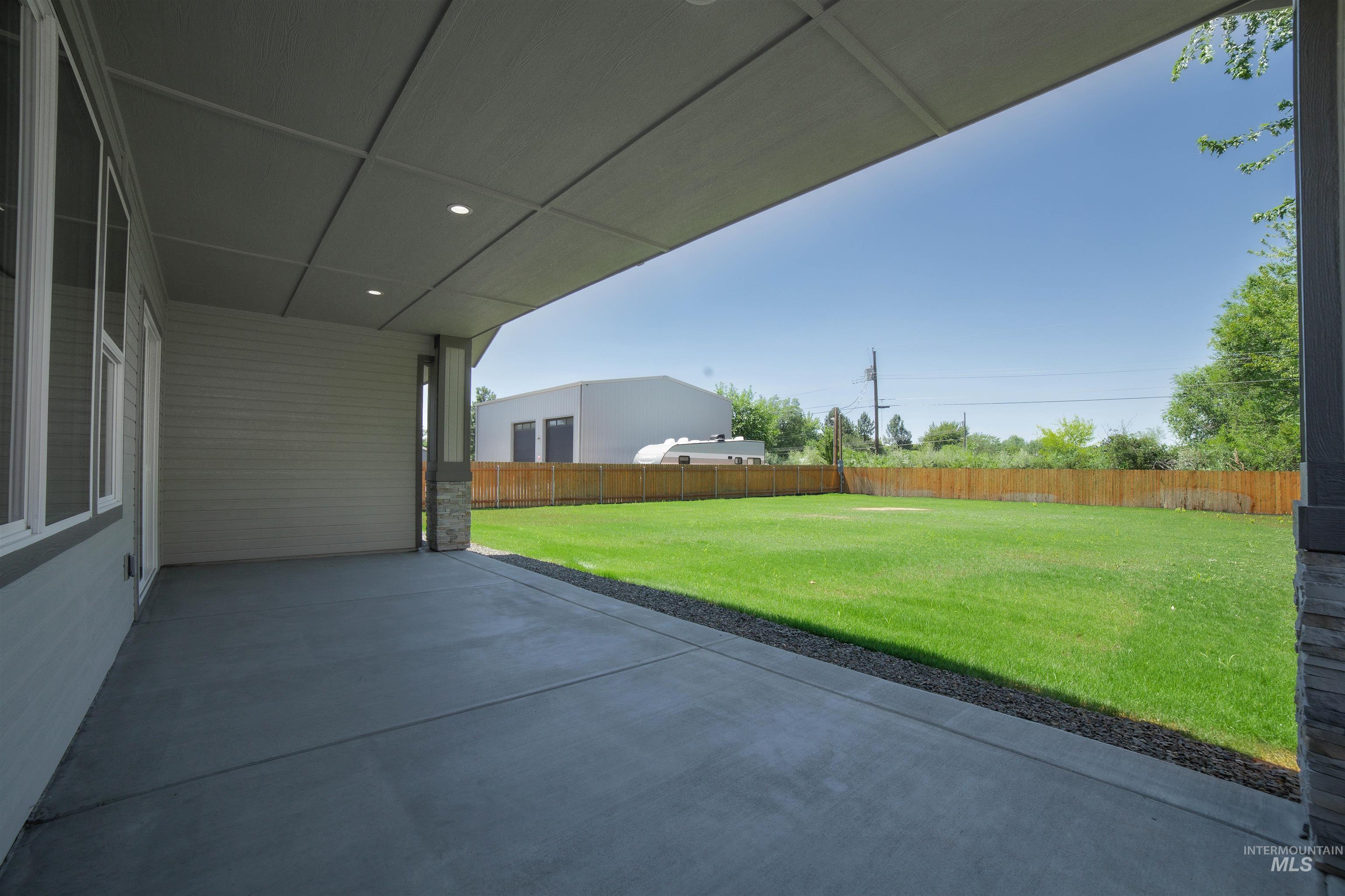 Fenced backyard featuring a patio