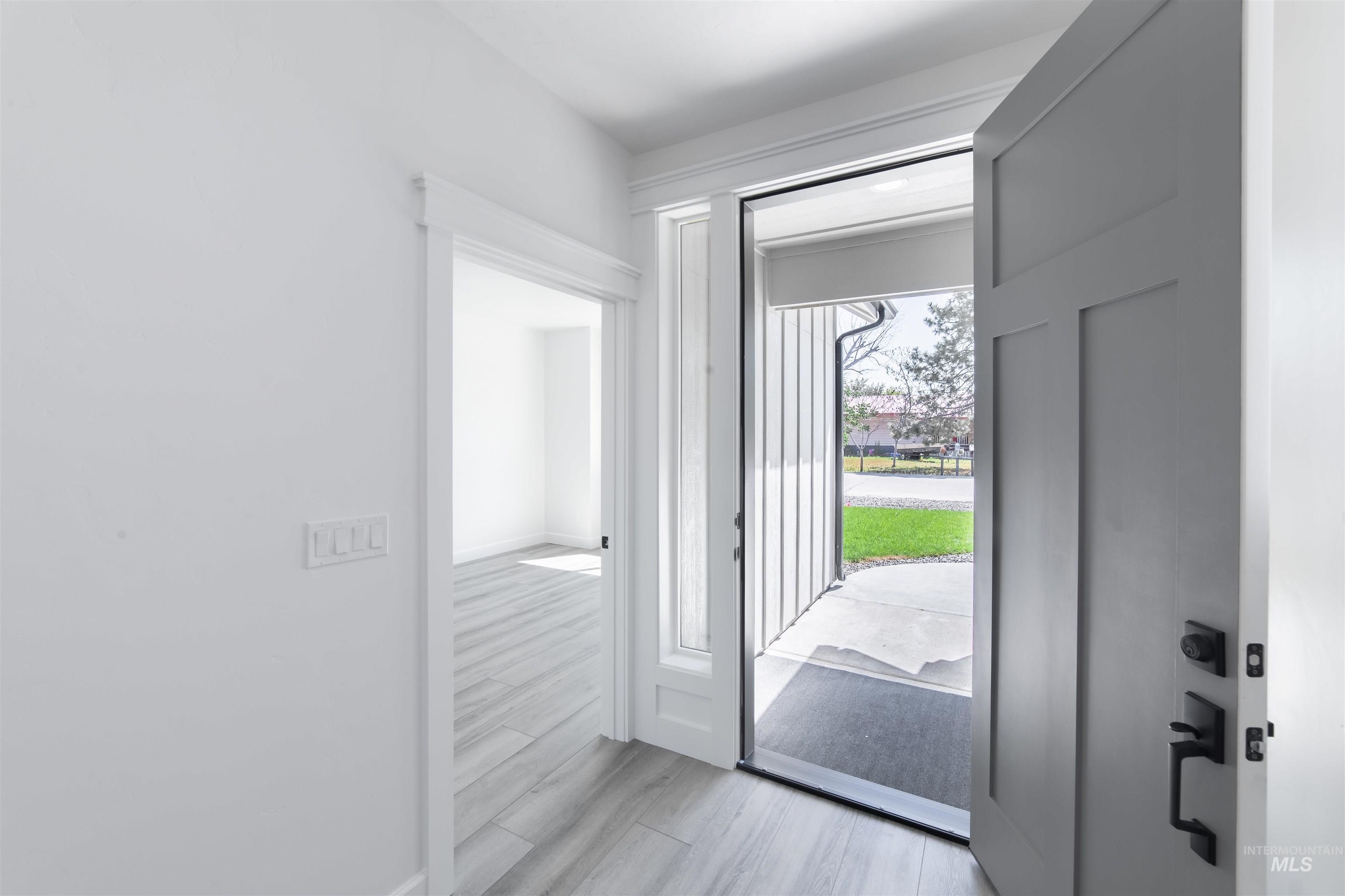 Foyer featuring baseboards and light wood-type flooring