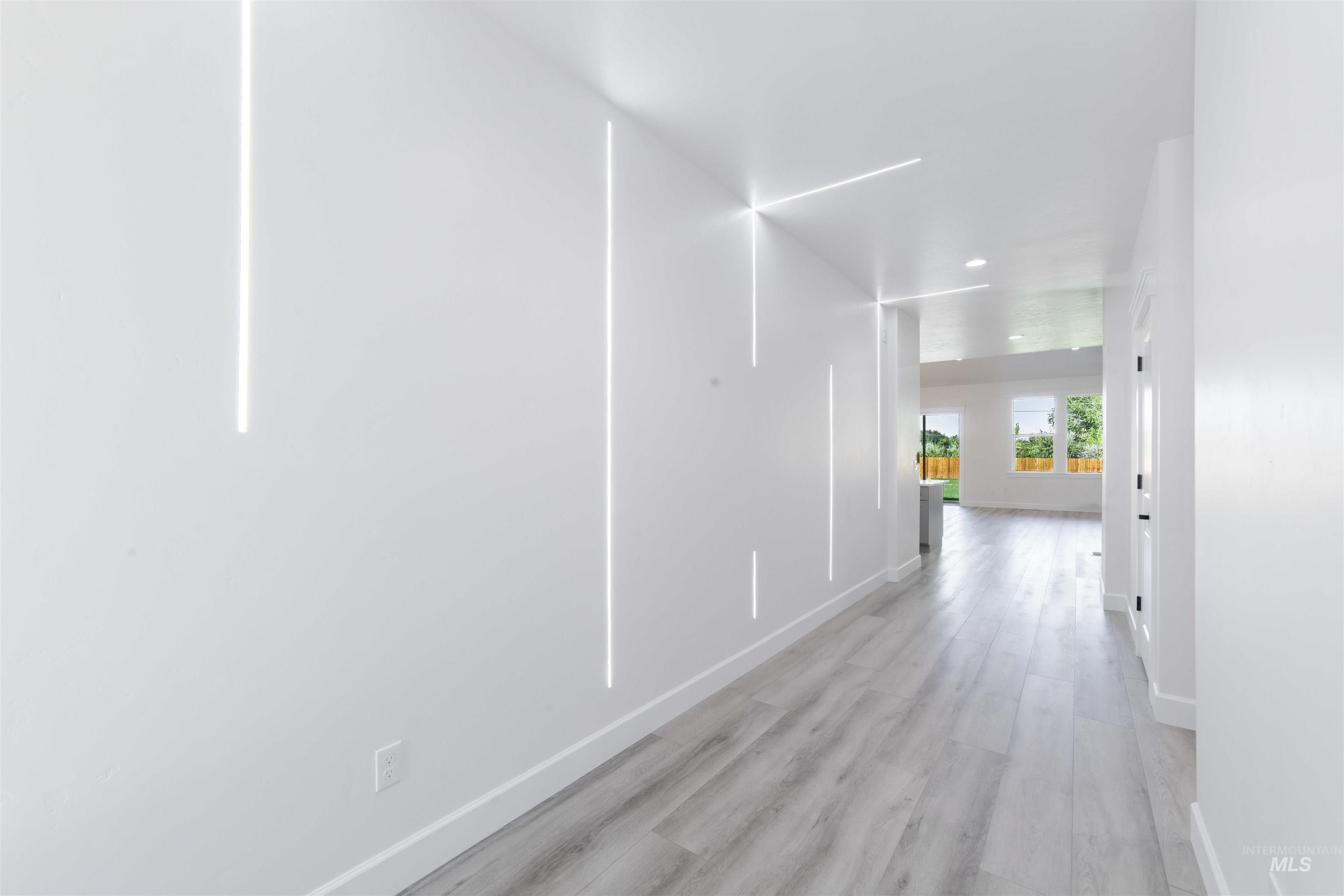 Hall featuring light wood-style flooring and recessed lighting