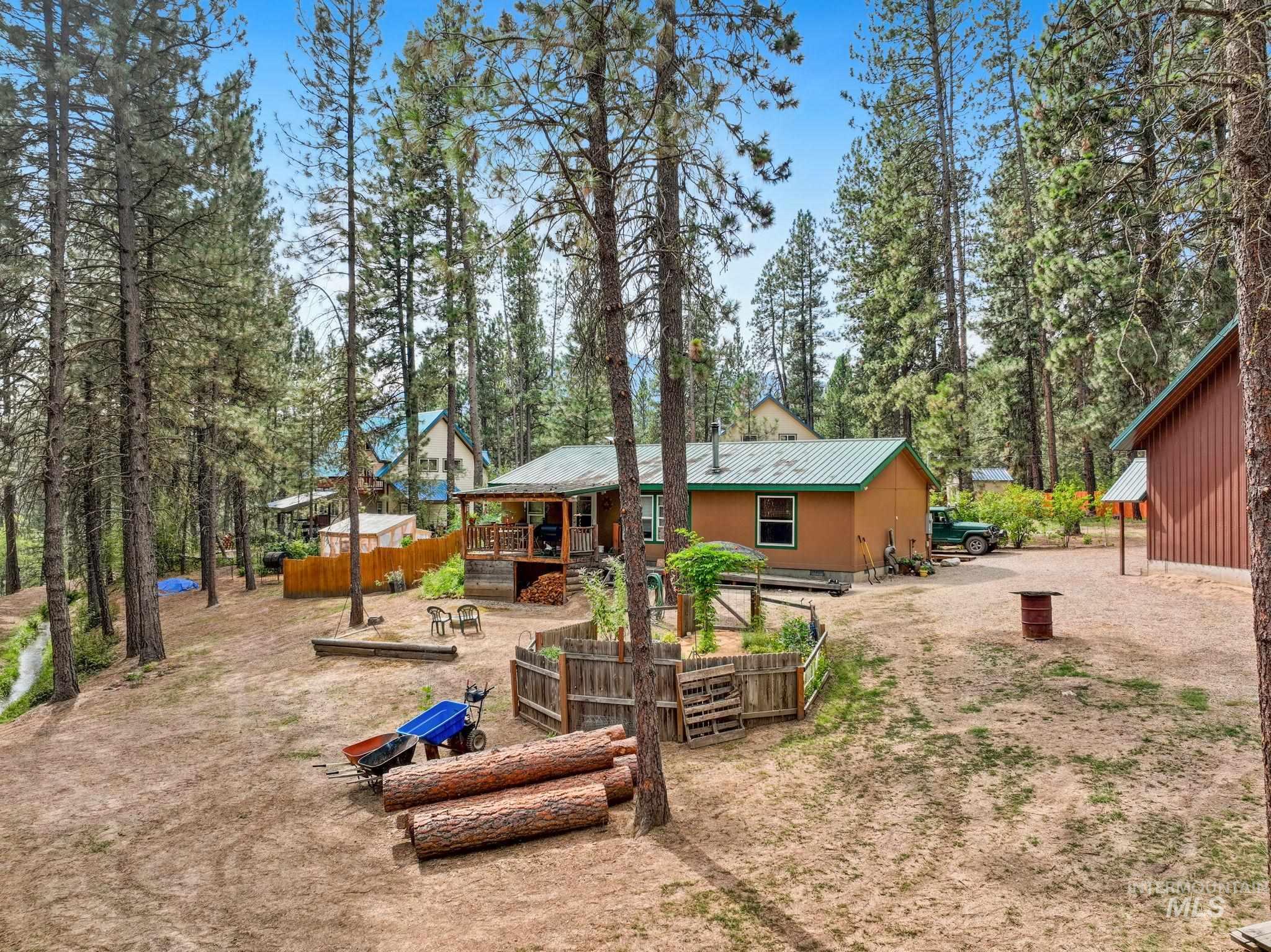 Rear view of property with a metal roof and a wooden deck
