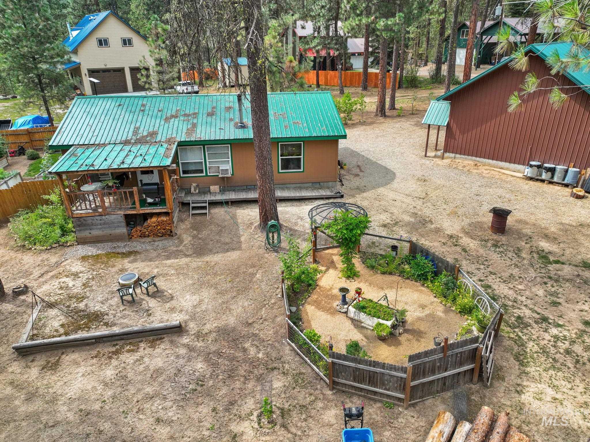 Back of property featuring a fenced backyard, a wooden deck, and a metal roof