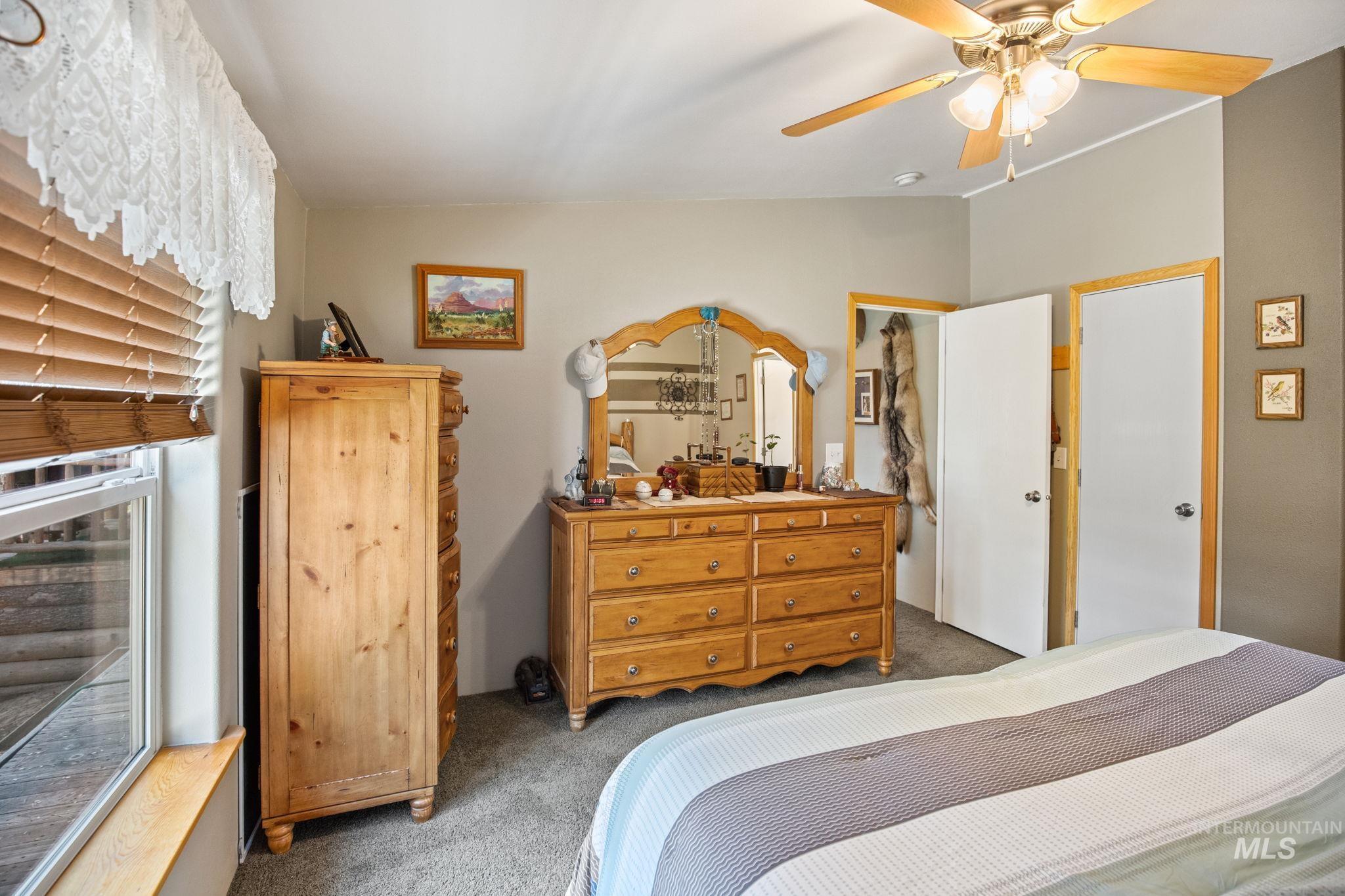 Carpeted bedroom with ceiling fan