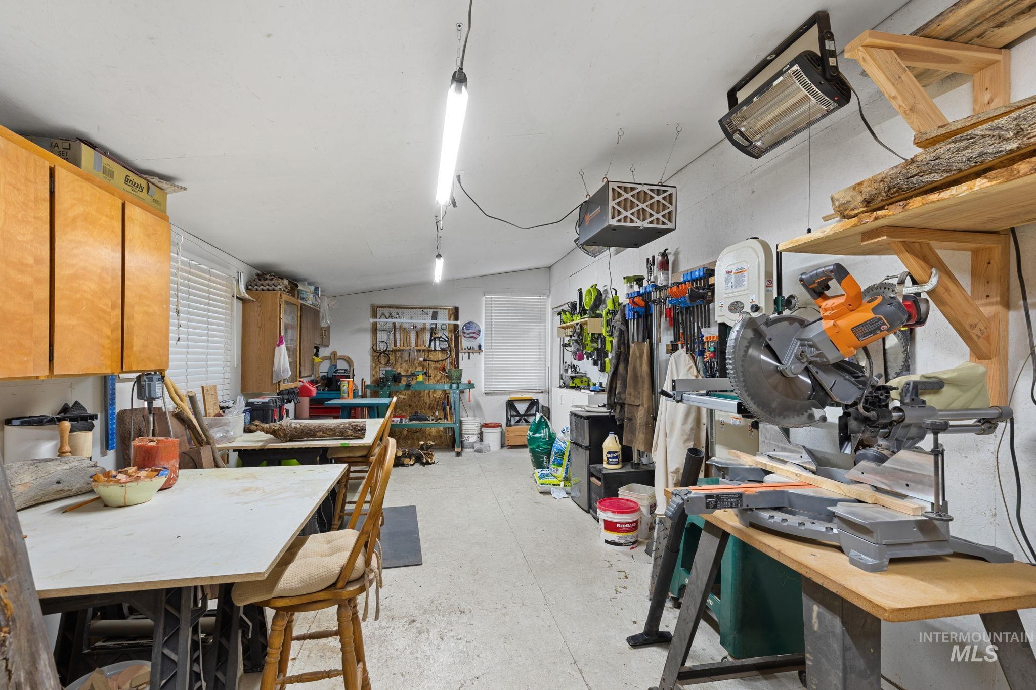 Below grade area with a workshop area and a heating unit