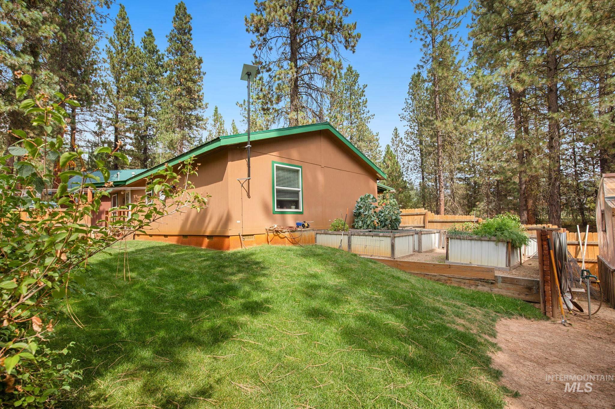 View of side of property with a garden and a deck