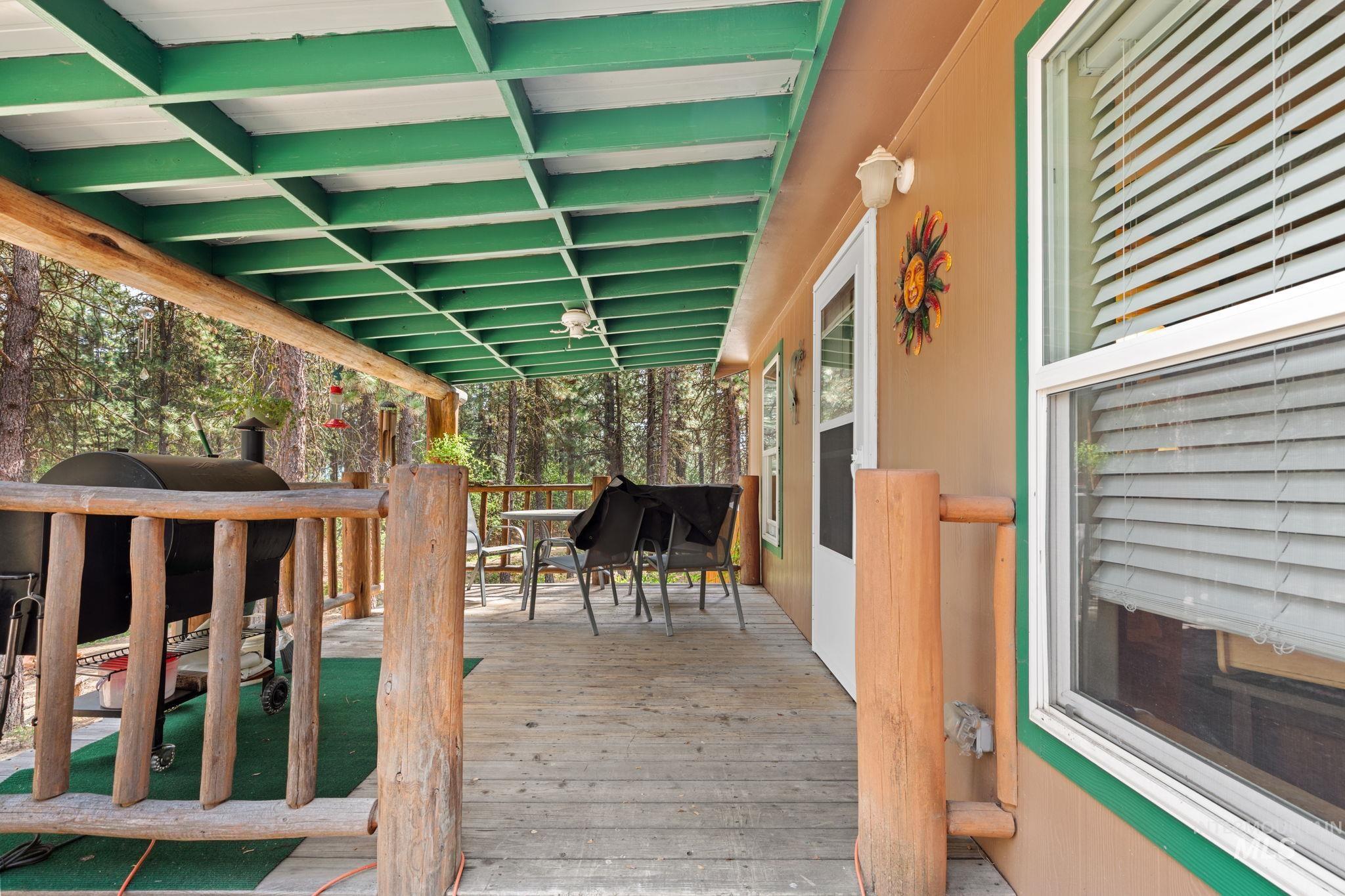 Wooden deck featuring outdoor dining space and area for grilling