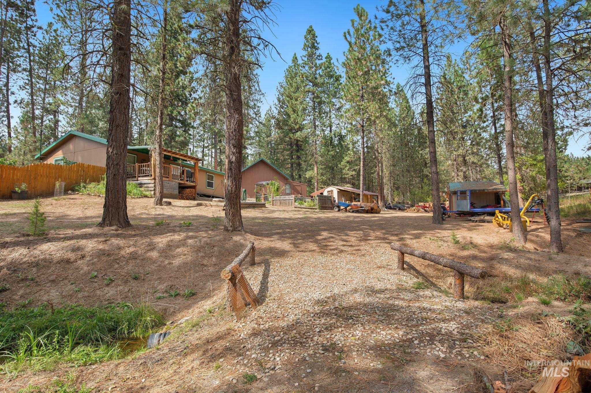 View of yard featuring a deck and an outbuilding