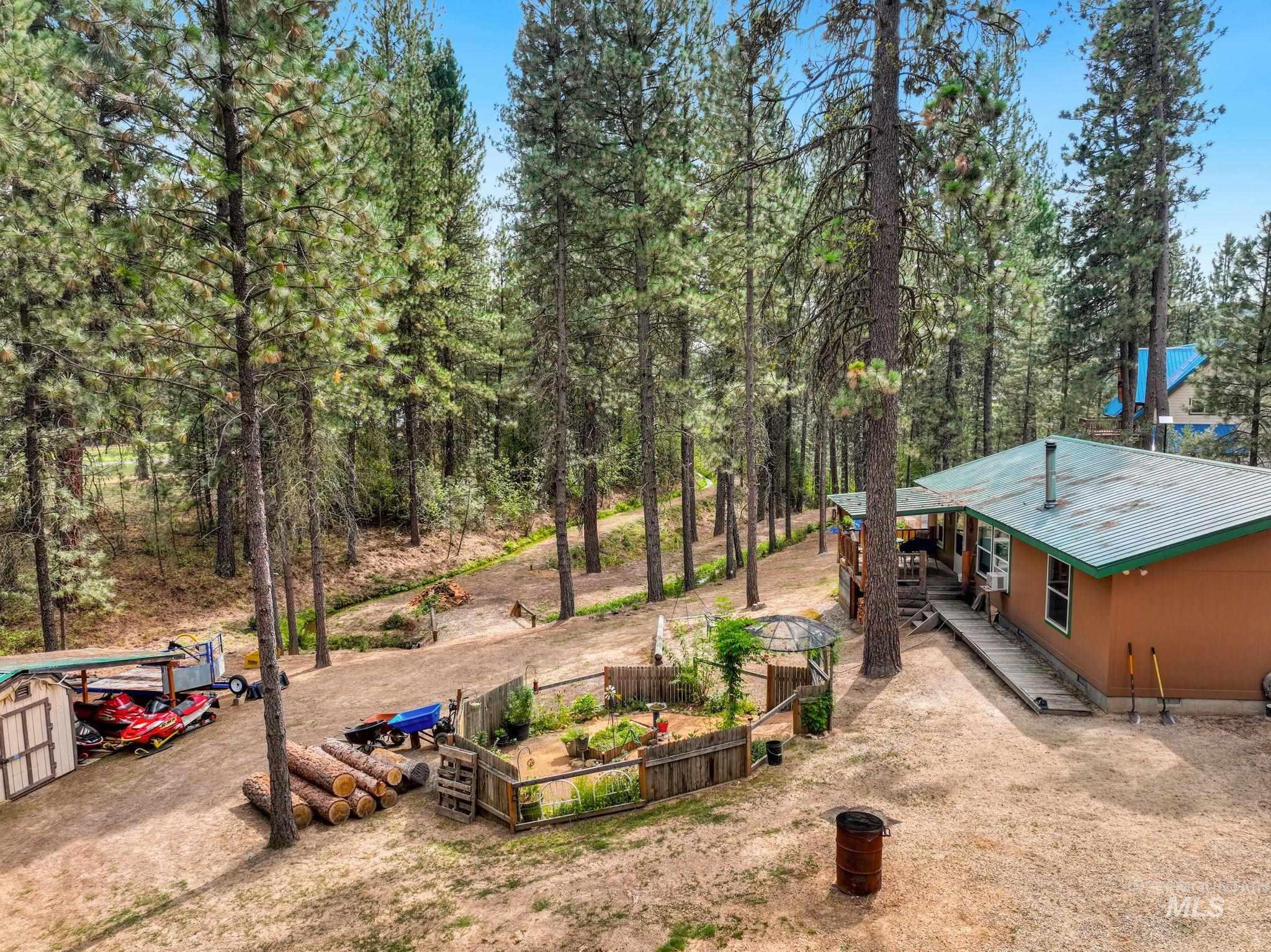 View of yard featuring a wooden deck and a view of trees