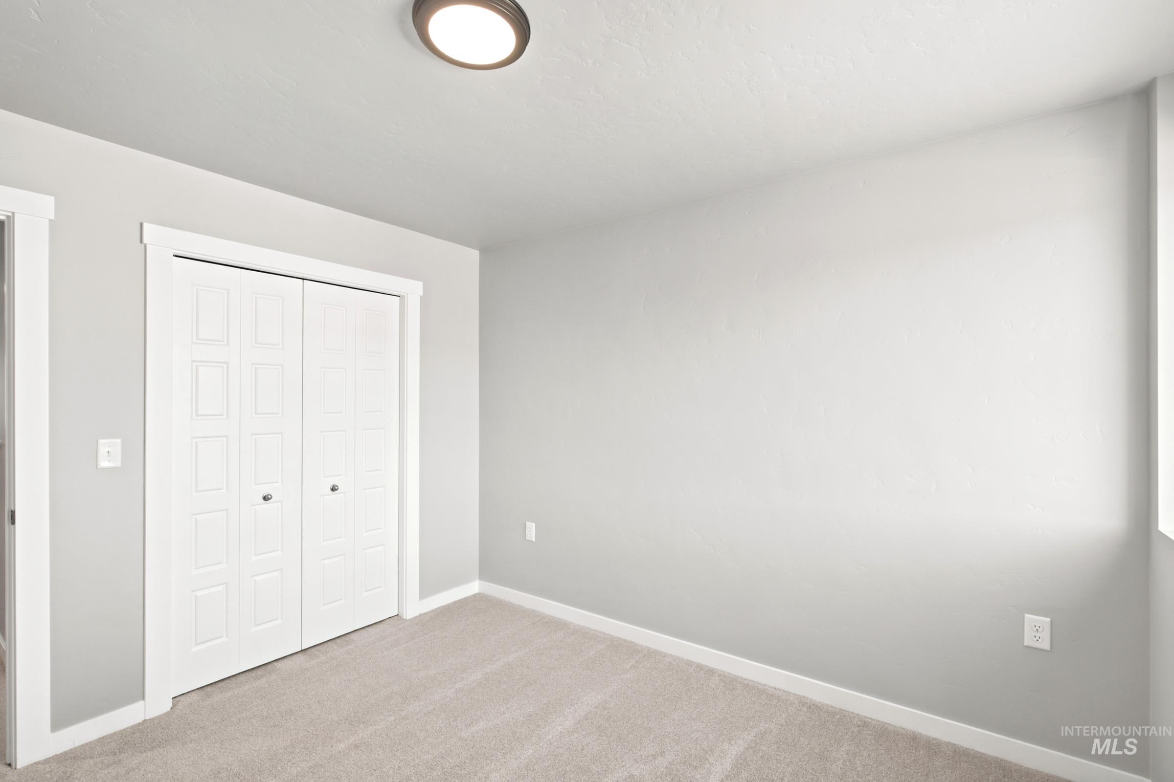 Room featuring neutral wall paint, light-colored carpet flooring, and white trim