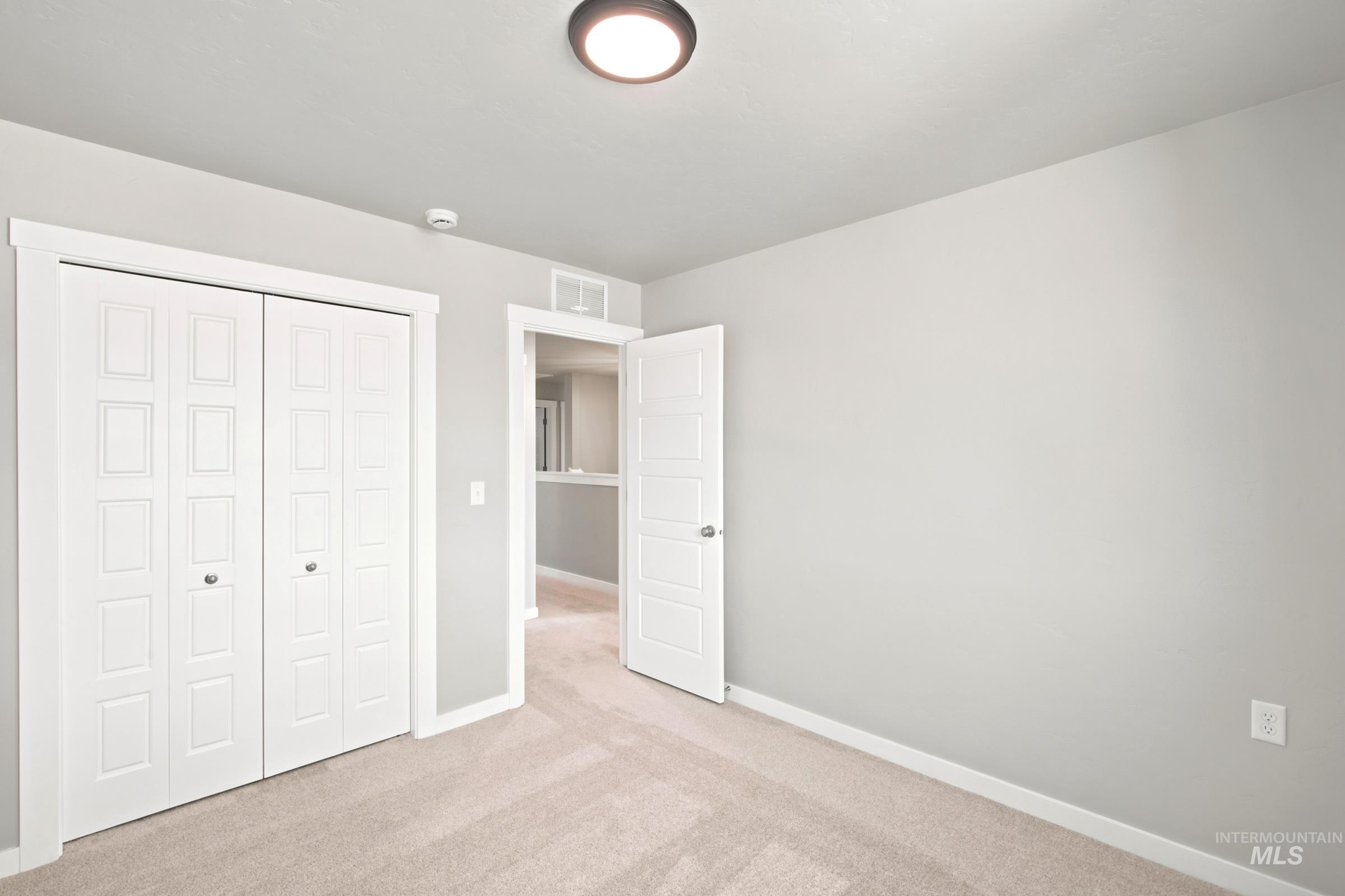 Neutral-toned carpeting paired with light gray wall paint