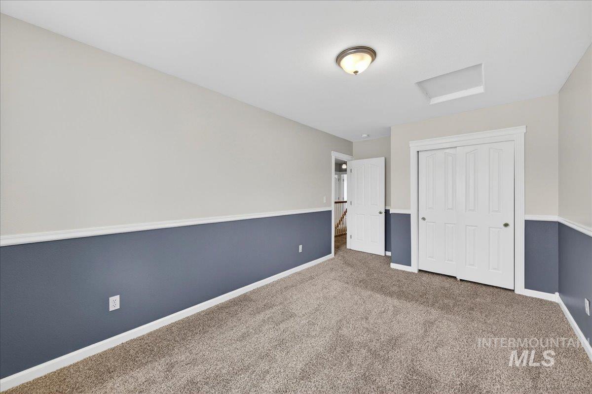 Unfurnished bedroom featuring carpet and a closet