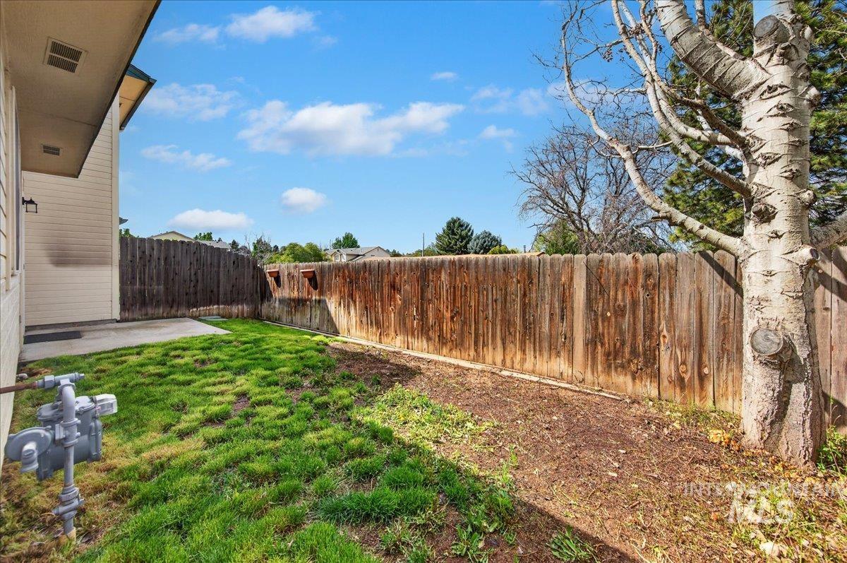 Fenced backyard with a patio
